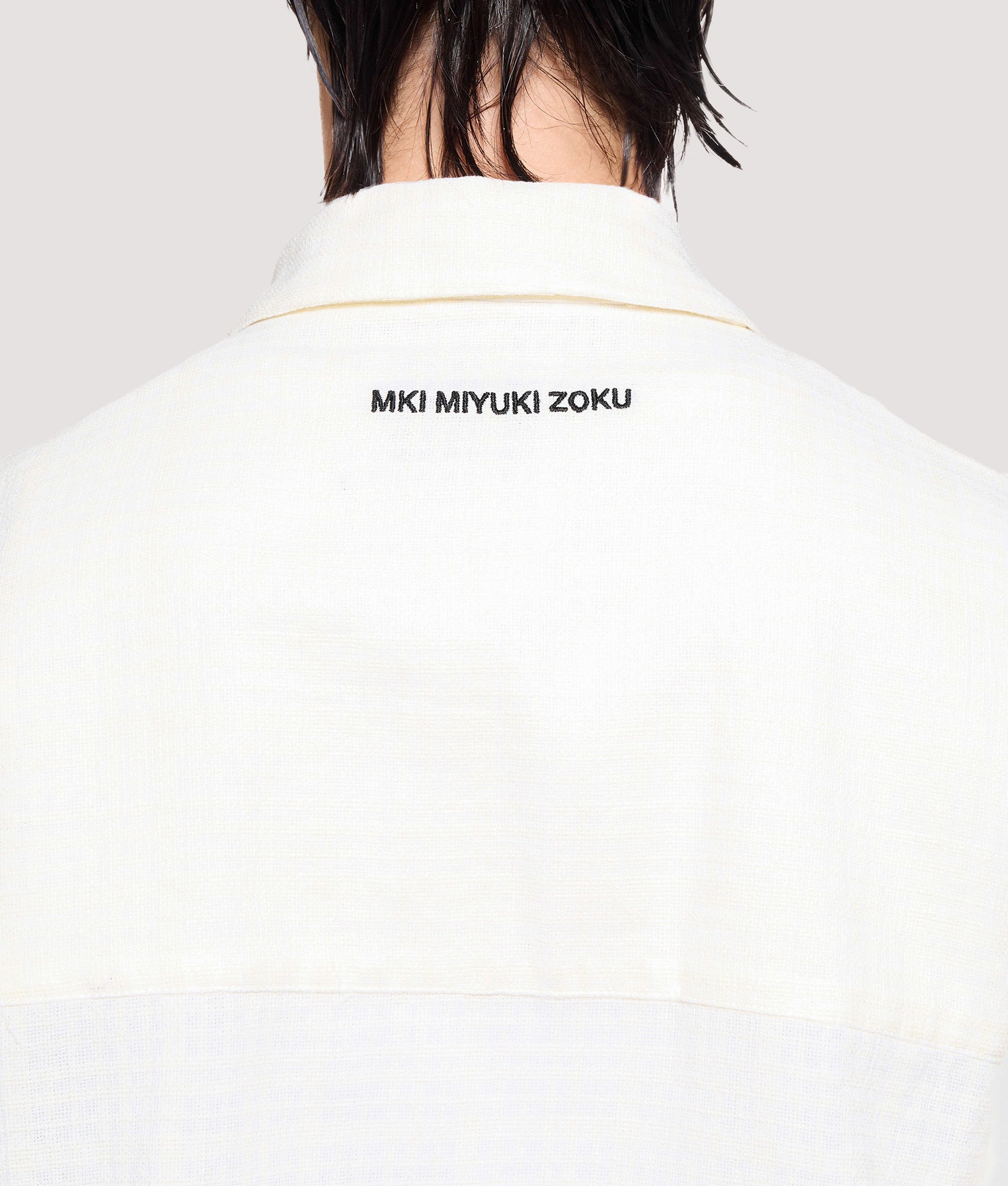 MKI MIYUKI ZOKU Box Fit Loose Weave Check Rider in Bone at EQVVS Menswear. Back detail shot.