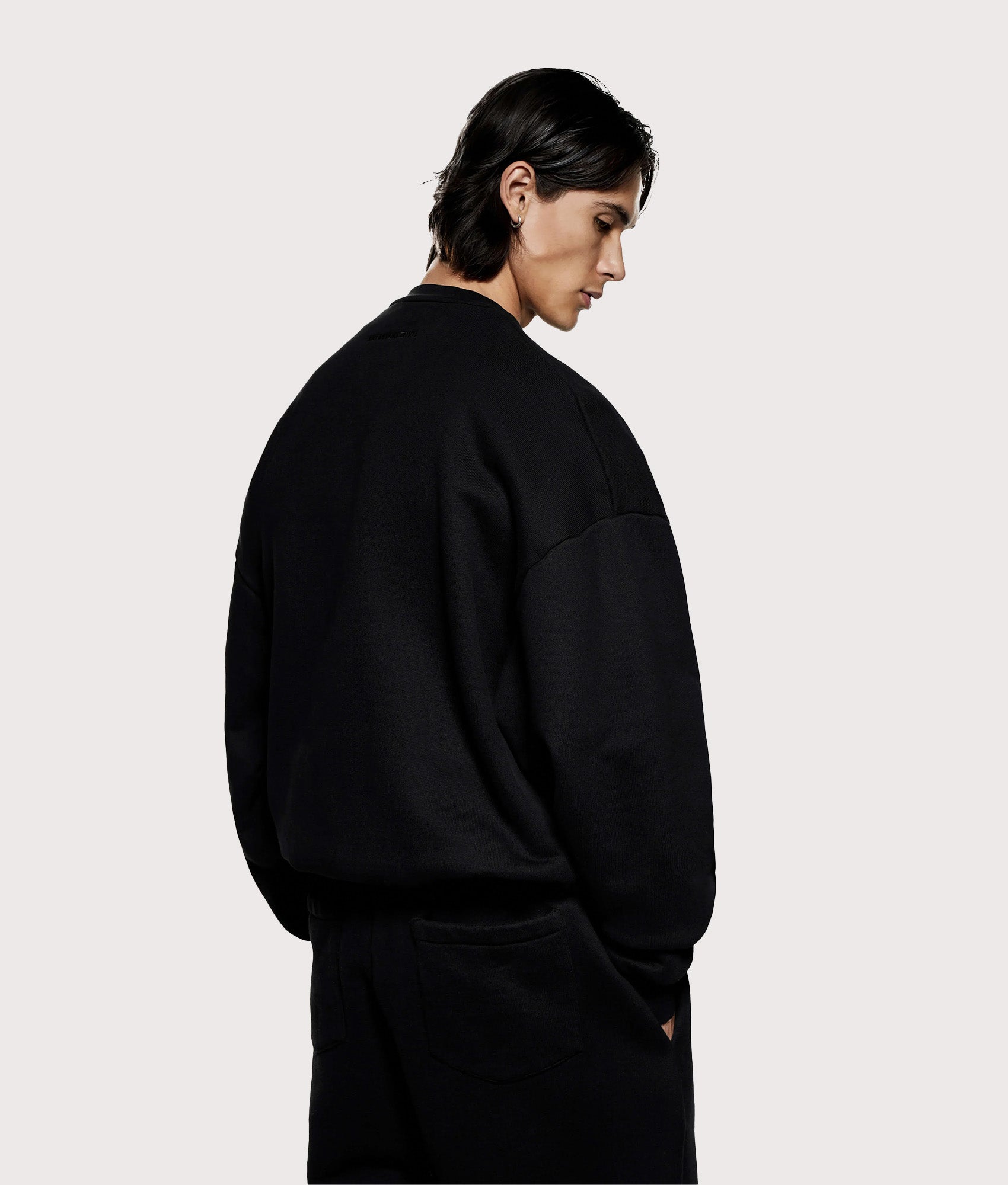 MKI Miyuki Zoku 800 GSM Superweight Crewneck Sweatshirt in Black at EQVVS. Model back shot.