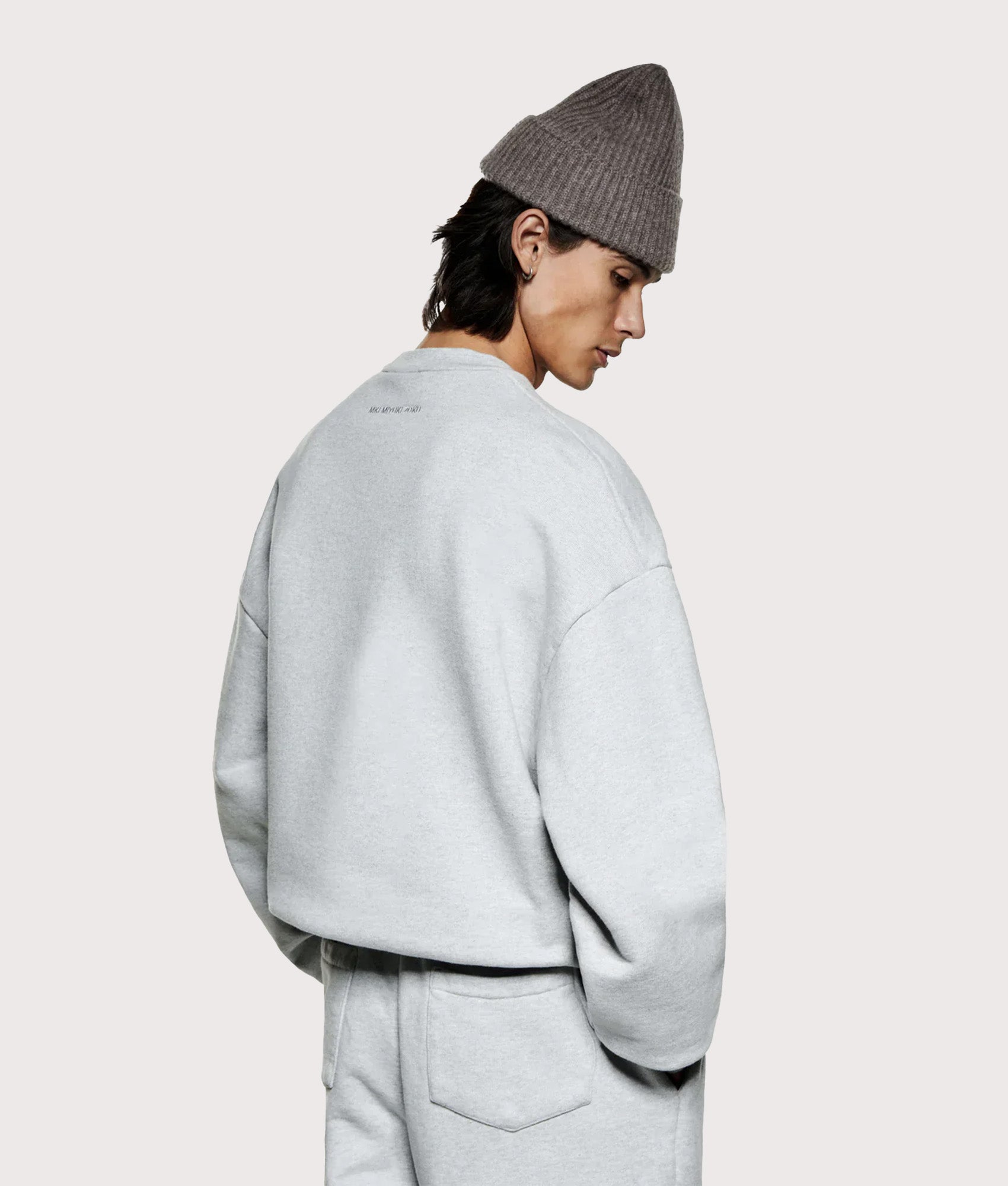 Oversized 800 GSM Superweight Sweatshirt in Grey by MKI MIYUKI ZOKU at EQVVS. Angled model back shot.