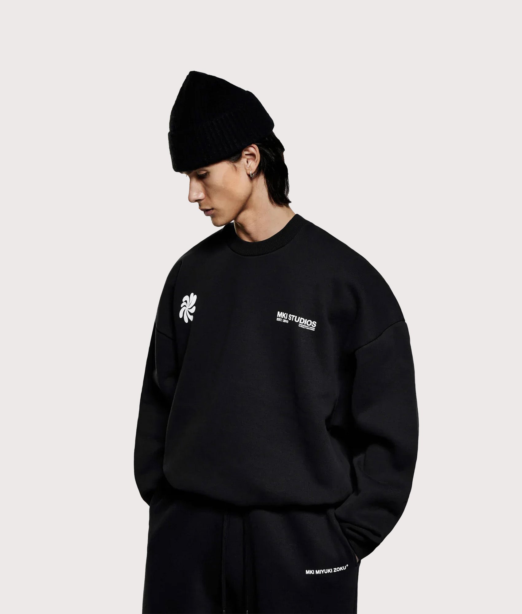 MKI MIYUKI ZOKU Oversized Abstract Crewneck Sweatshirt in Black at EQVVS Menswear. Angled model front shot.