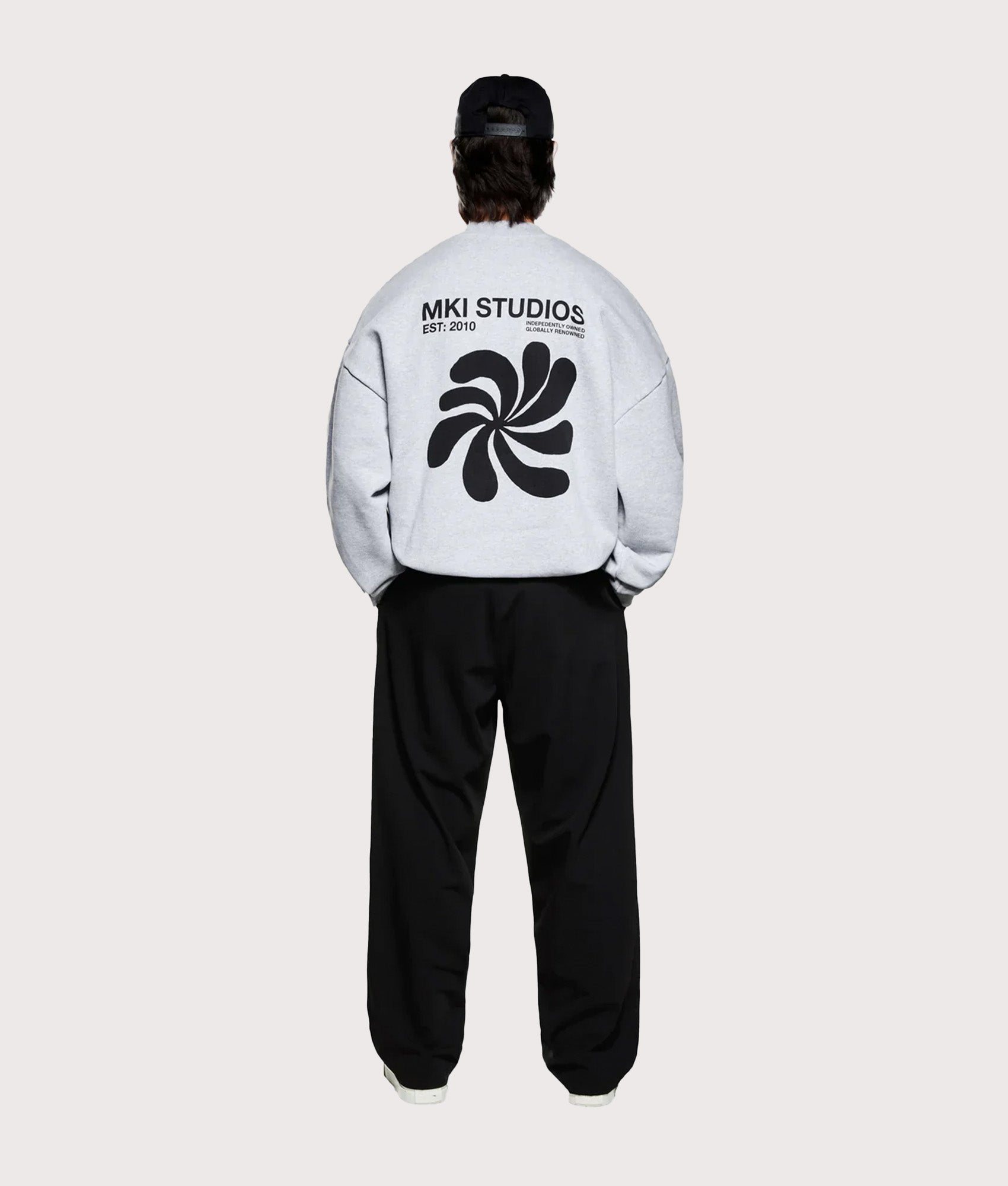 MKI MIYUKI ZOKU Oversized Abstract Crewneck Sweatshirt in Grey at EQVVS Menswear. Full model back shot.