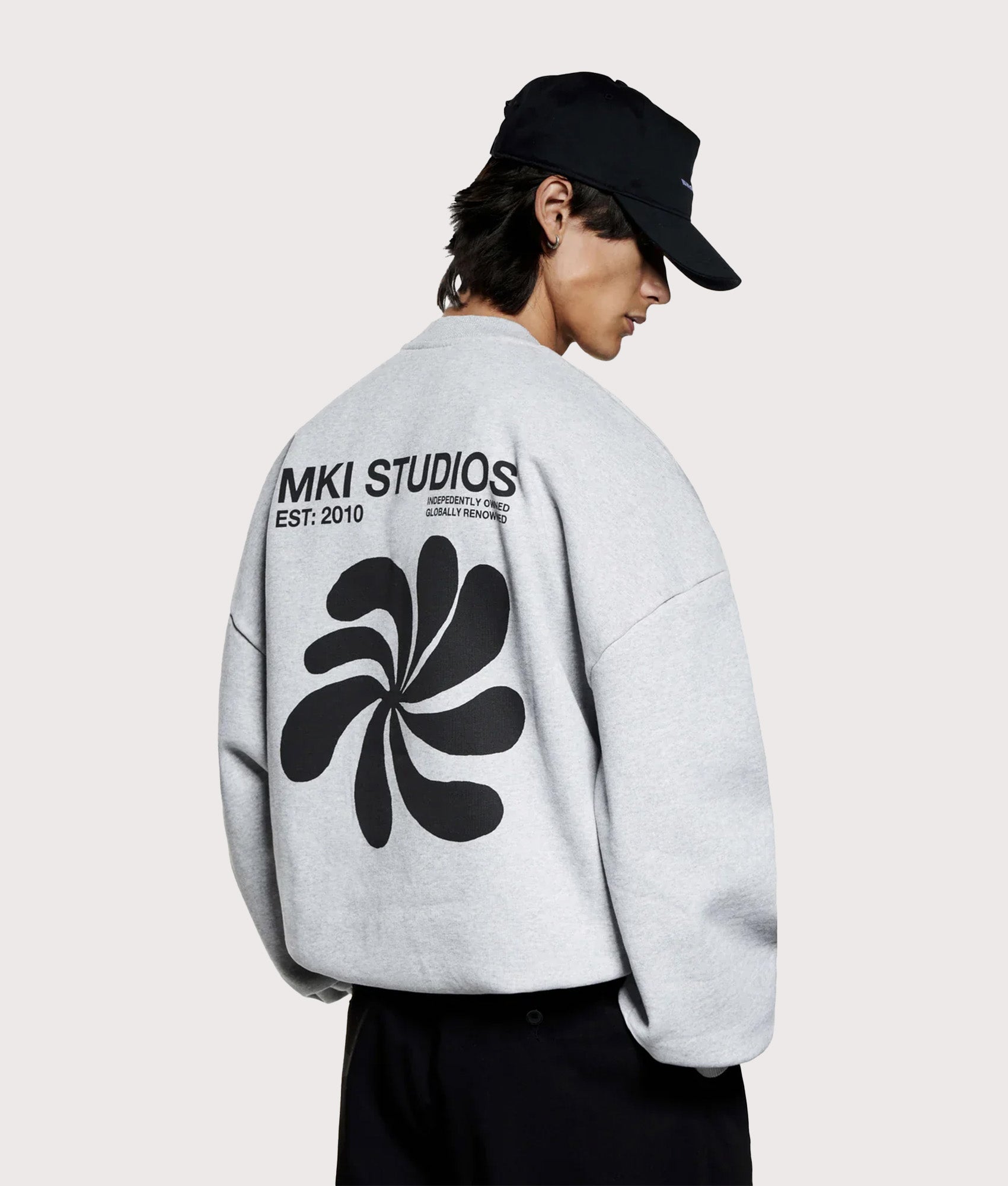 MKI MIYUKI ZOKU Oversized Abstract Crewneck Sweatshirt in Grey at EQVVS Menswear. Angled model back shot.