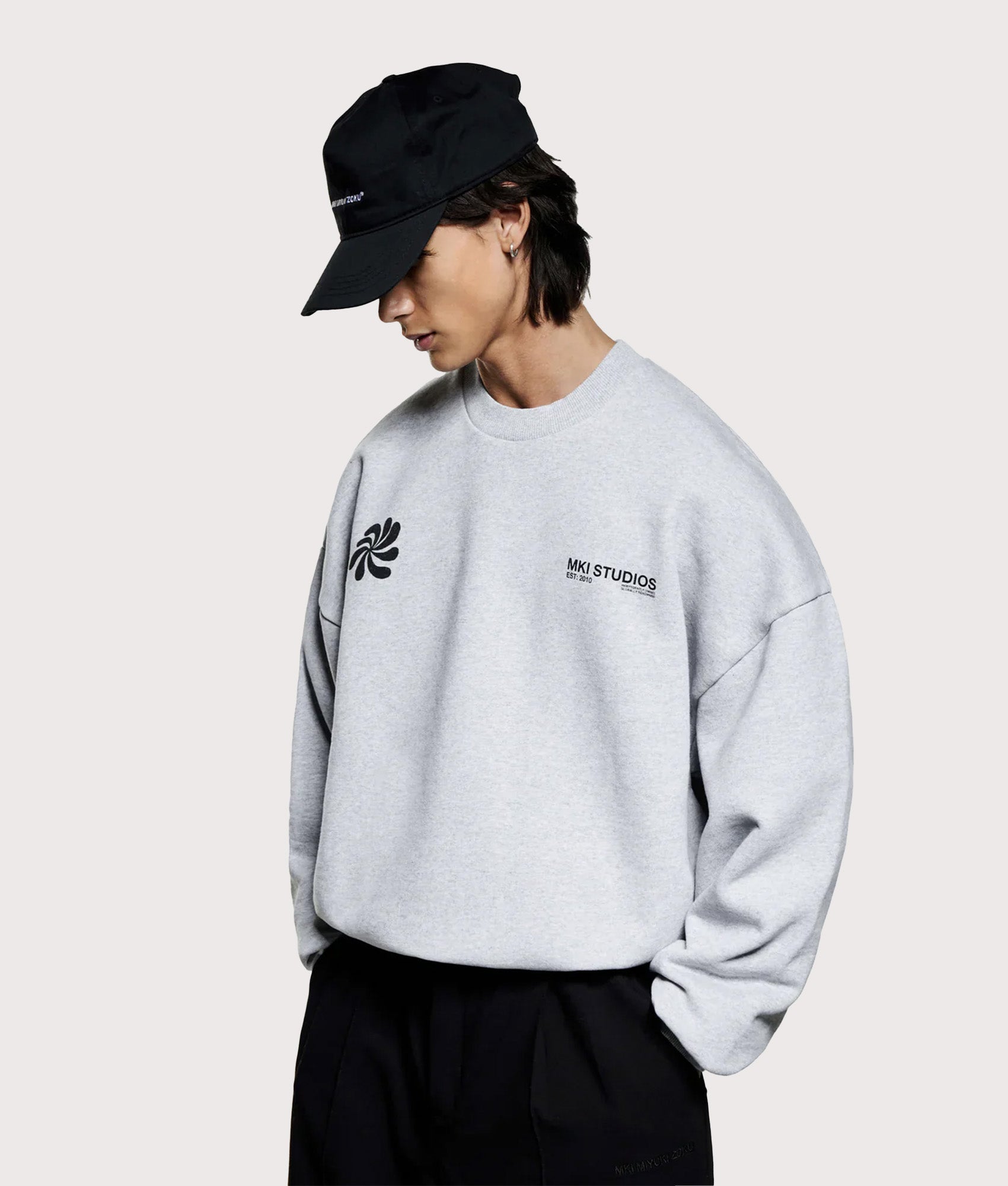 MKI MIYUKI ZOKU Oversized Abstract Crewneck Sweatshirt in Grey at EQVVS Menswear. Angled model front shot.