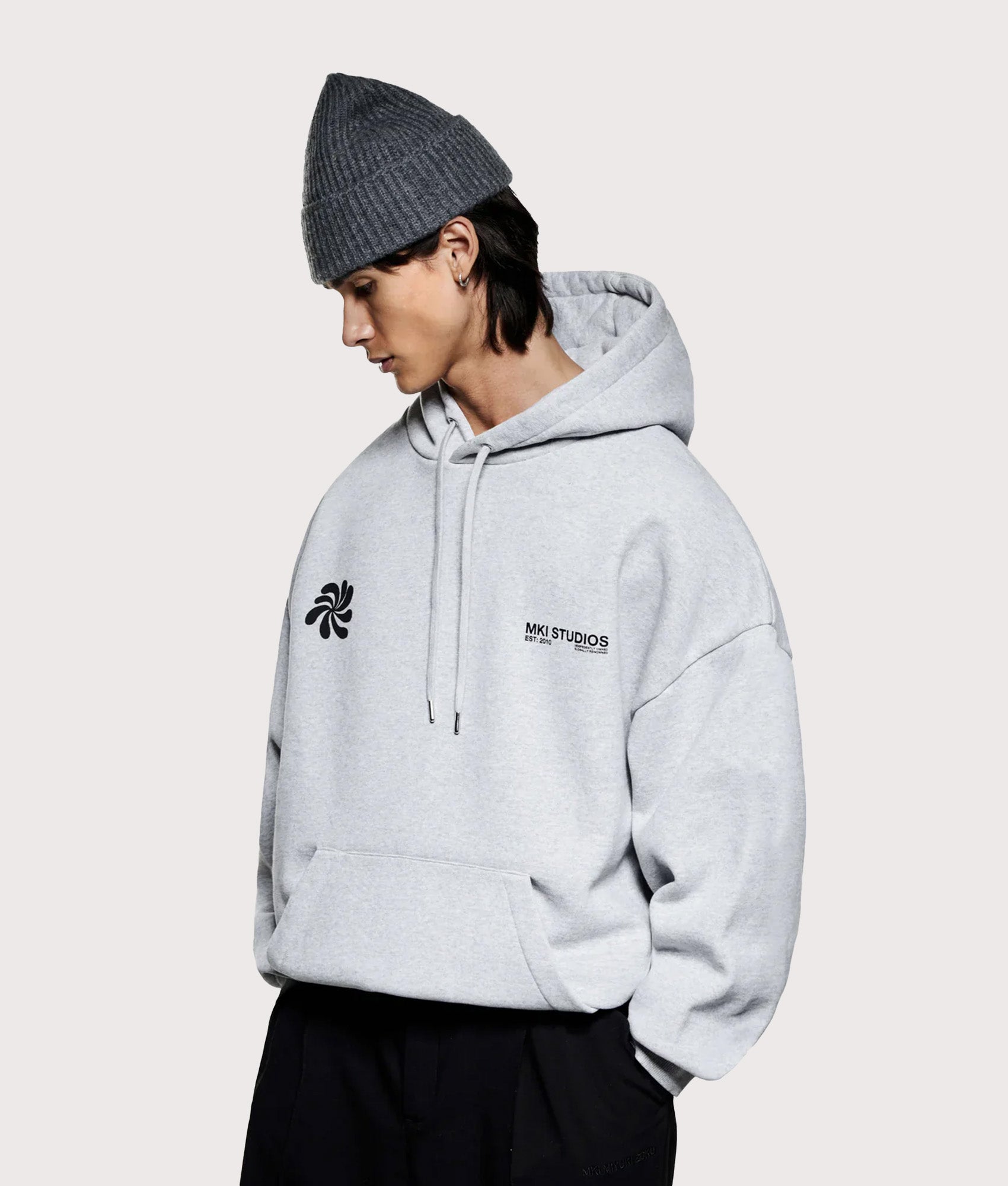MKI MIYUKI ZOKU Oversized Abstract Hoodie in Grey at EQVVS Menswear. Model front shot.