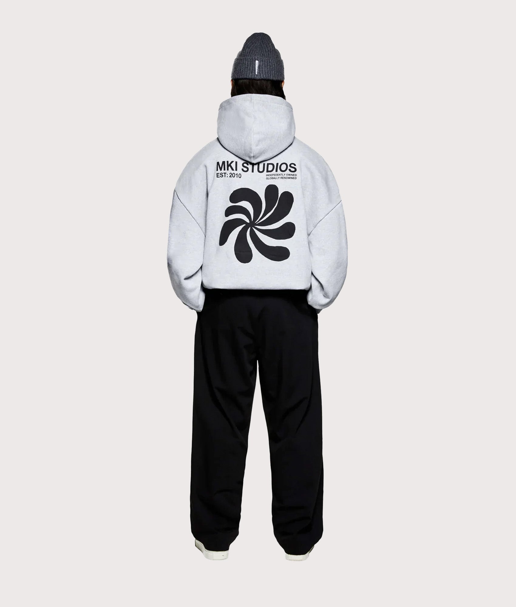 MKI MIYUKI ZOKU Oversized Abstract Hoodie in Grey at EQVVS Menswear. Model full back shot.