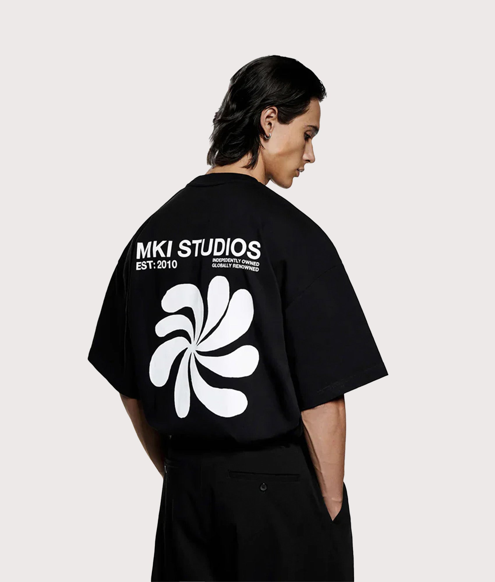 MKI MIYUKI ZOKU Oversized Abstract T-Shirt in Black at EQVVS Menswear. Model back shot.