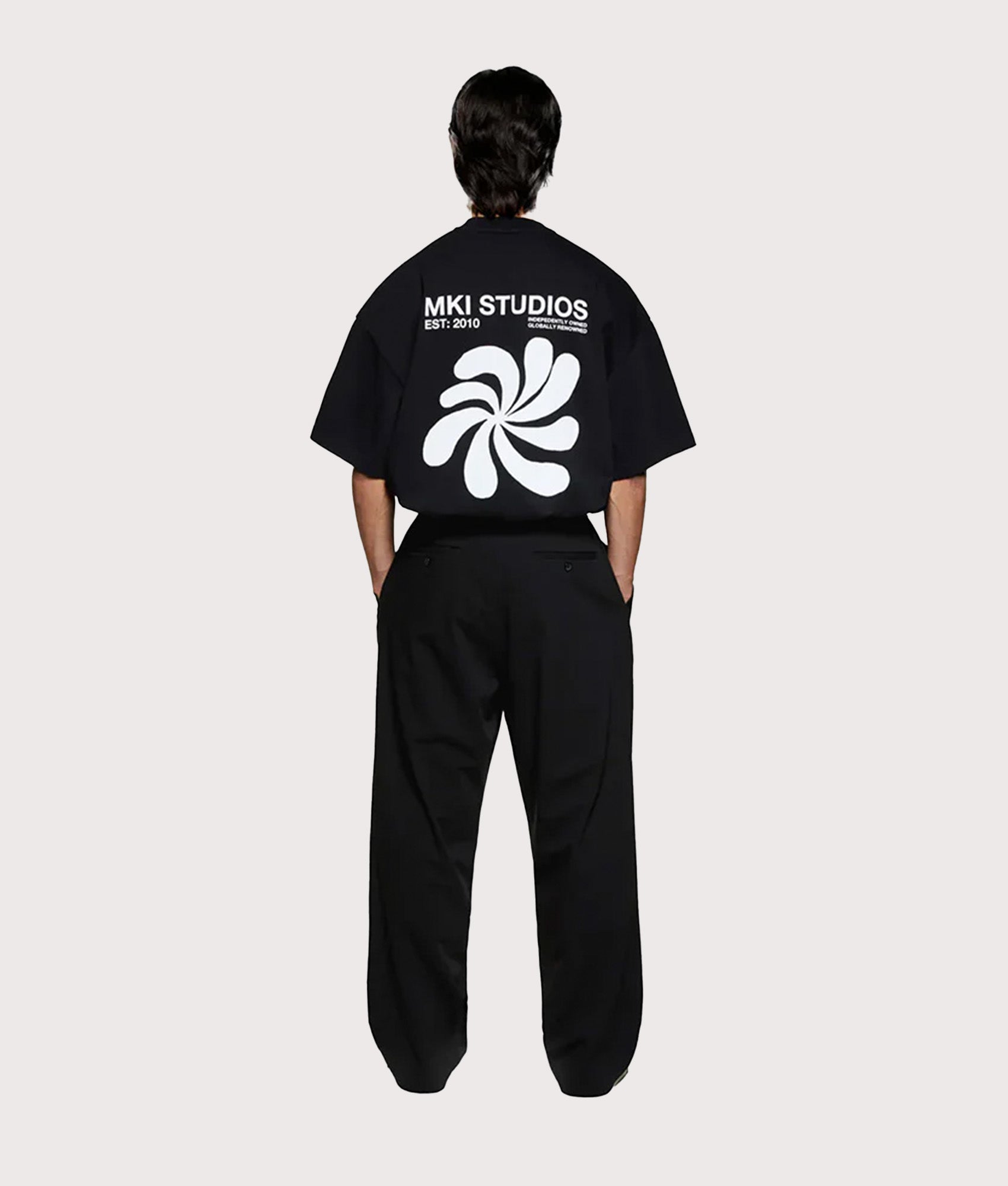 MKI MIYUKI ZOKU Oversized Abstract T-Shirt in Black at EQVVS Menswear. Model back shot.