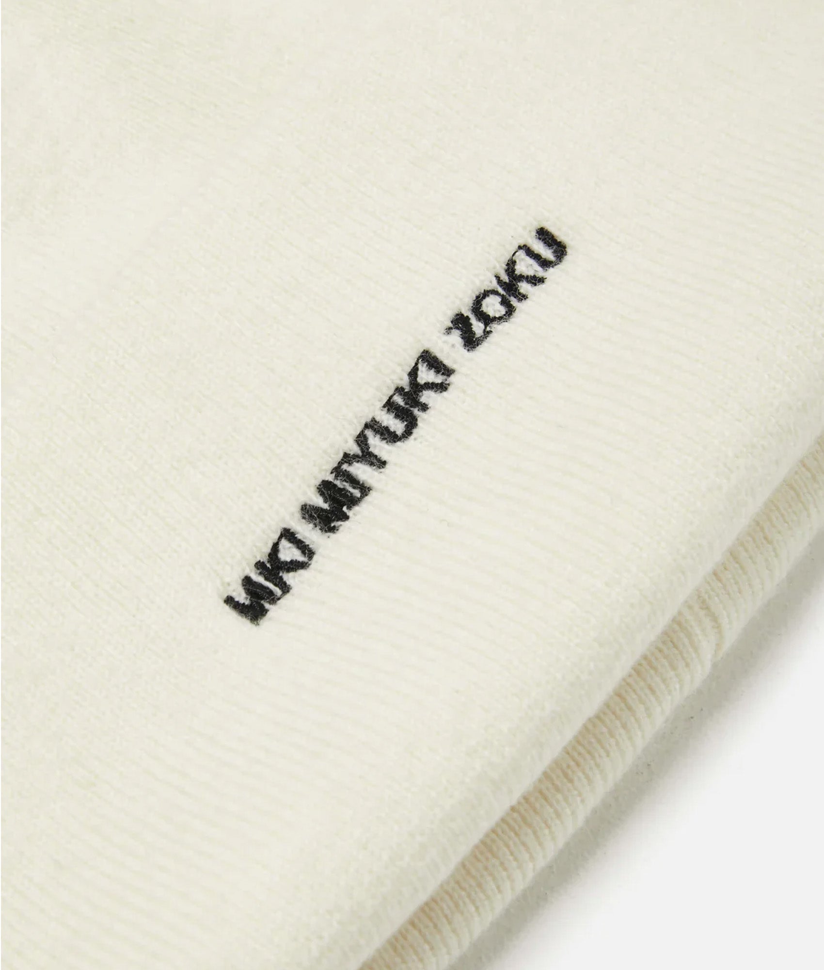 MKI MIYUKI ZOKU Embroidered Merino Beanie in Off White at EQVVS Menswear. Detail shot.