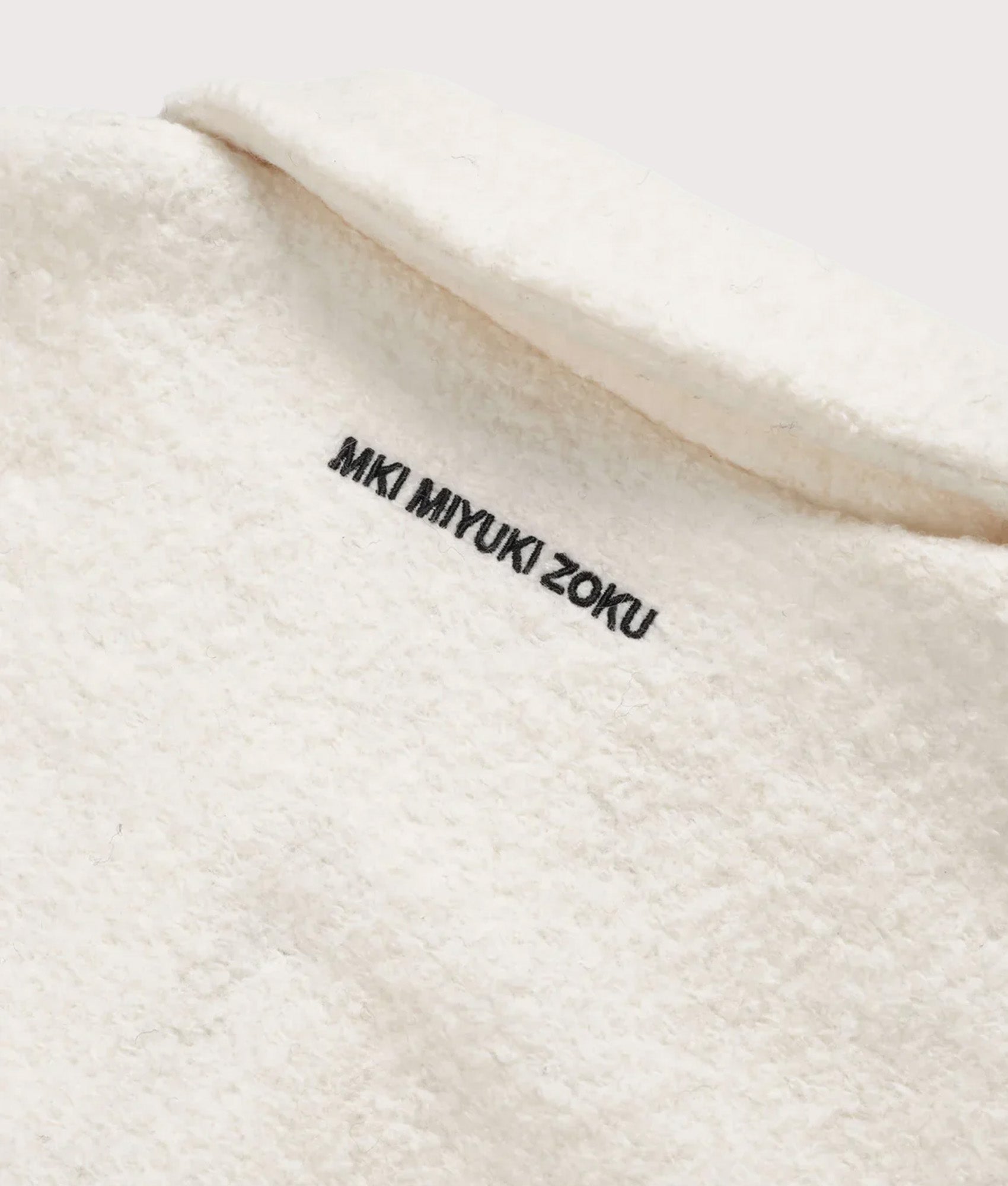 MKI MIYUKI ZOKU Oversized Fit Boucle Quarter Zip Overshirt in Off White at EQVVS Menswear. Detail shot.