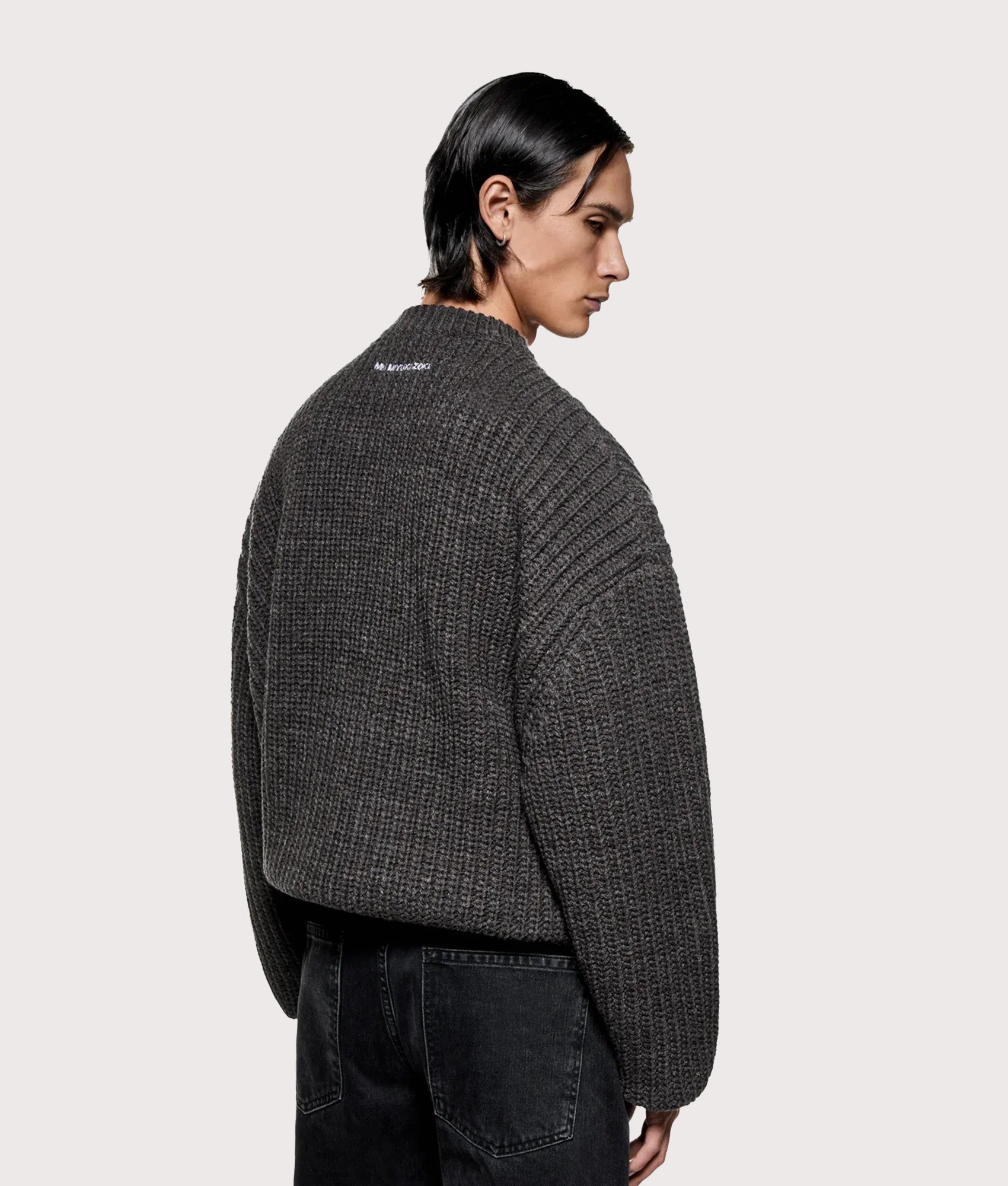 MKI MIYUKI ZOKU Oversized Chunky Rib Knit Crewneck Jumper in Charcoal melange at EQVVS Menswear. Model back shot.