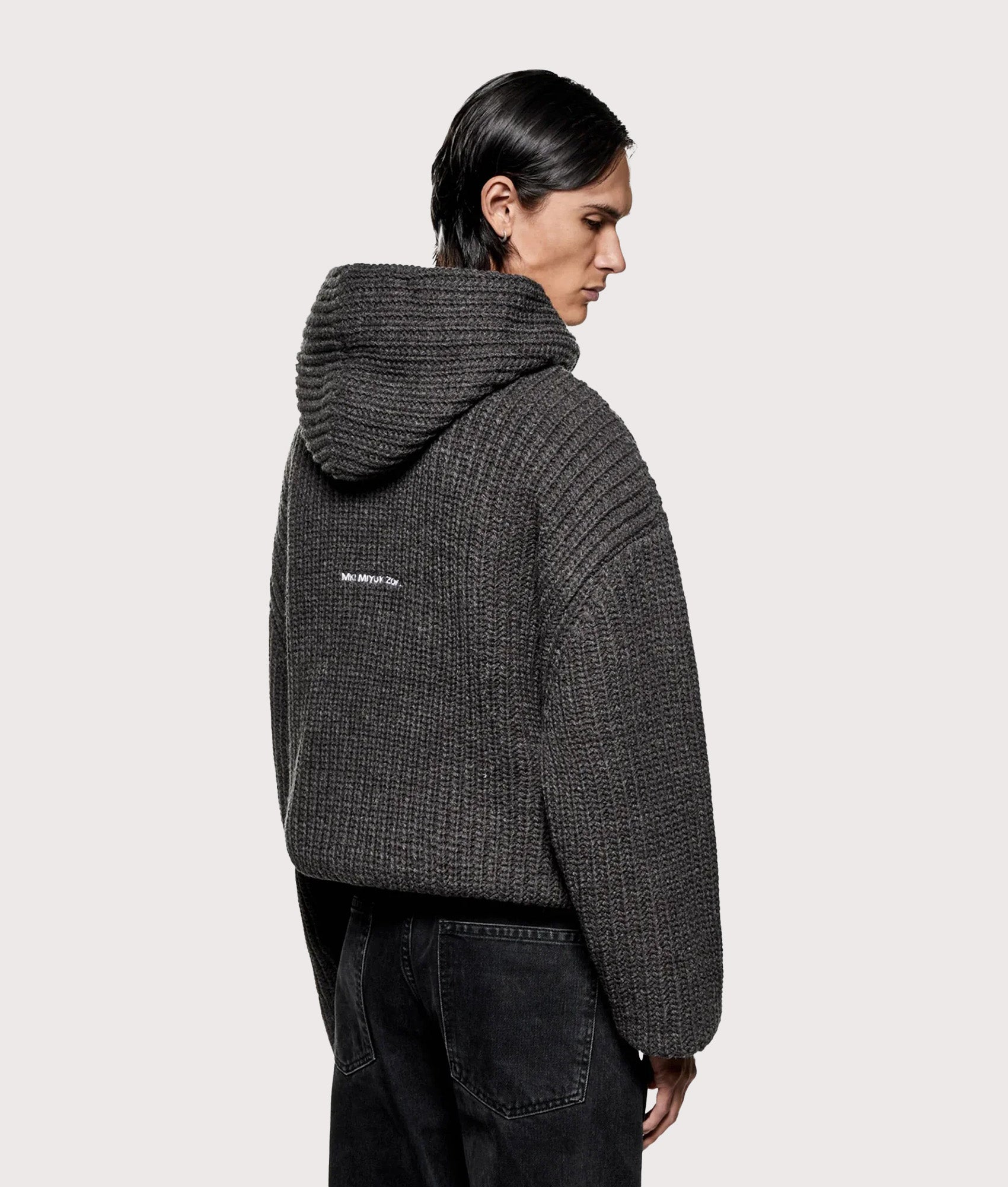 MKI MIYUKI ZOKU Oversized Chunky Rib Knit Hoodie in Charcoal Melange at EQVVS Menswear. Model back shot.