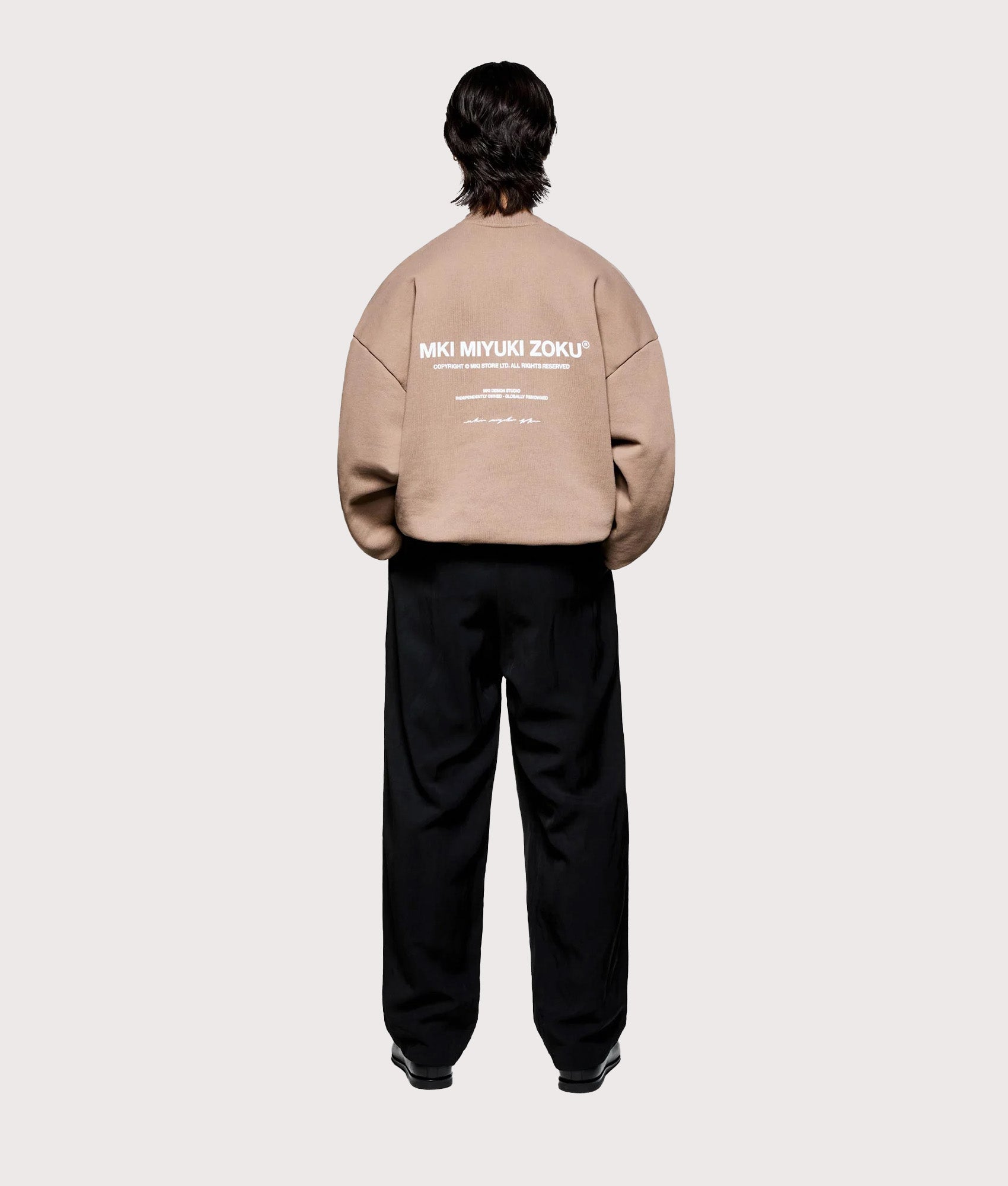 MKI MIYUKI ZOKU Oversized Design Studio Crewneck Sweatshirt in Mushroom. Full model back shot.