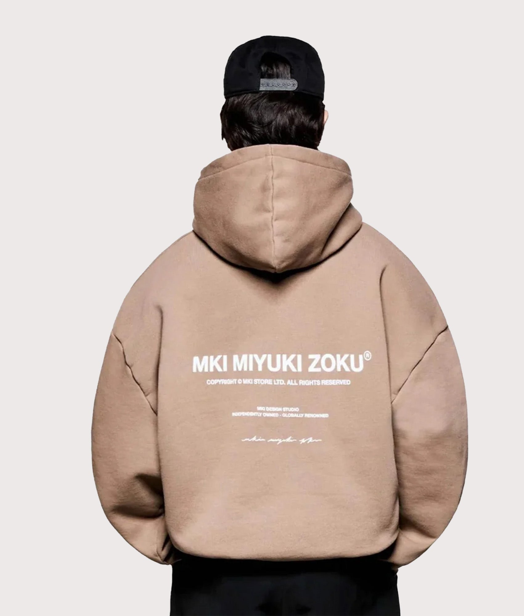 MKI MIYUKI ZOKU Oversized Design Studio Hoodie in Mushroom at EQVVS Menswear. Model Back shot.