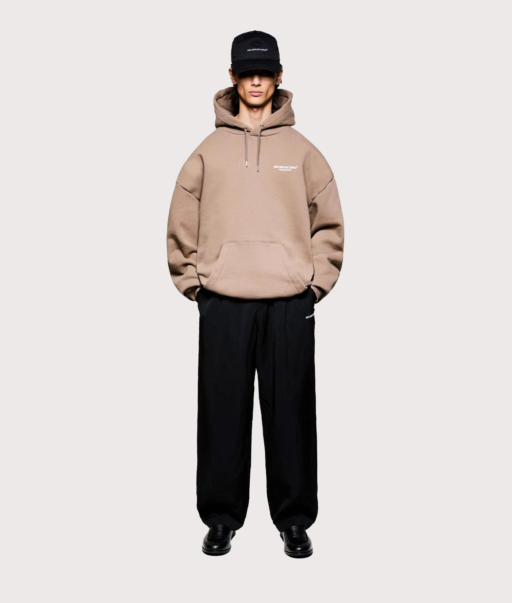 MKI MIYUKI ZOKU Oversized Design Studio Hoodie in Mushroom at EQVVS Menswear. Model full front shot.
