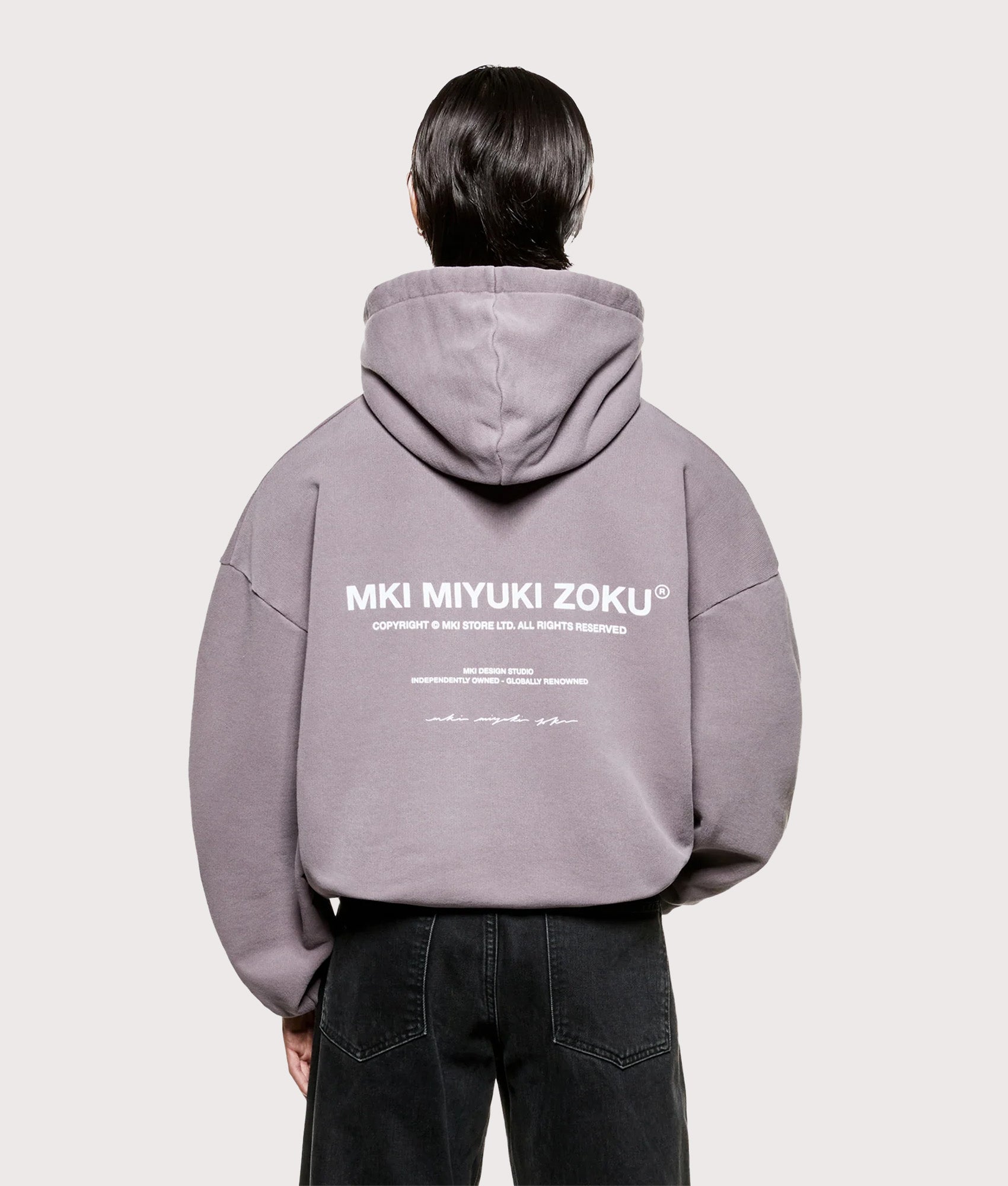 MKI MIYUKI ZOKU Oversized Design Studio Hoodie in Pigment Raisin at EQVVS Menswear. Model Back shot.