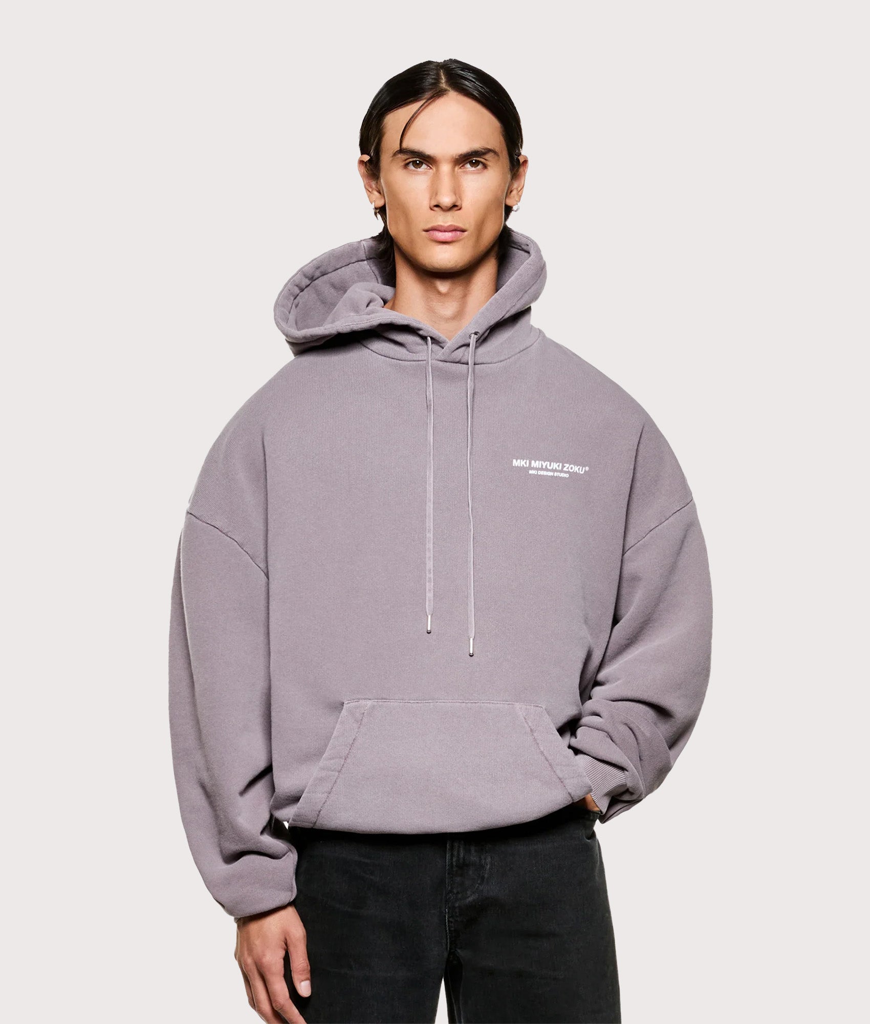 MKI MIYUKI ZOKU Oversized Design Studio Hoodie in Pigment Raisin at EQVVS Menswear. Model front shot.
