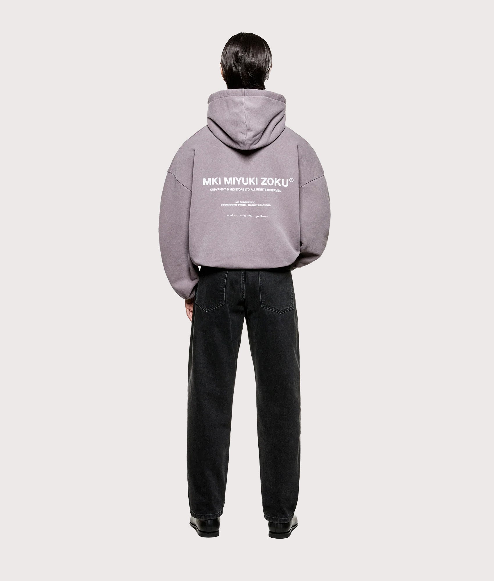 MKI MIYUKI ZOKU Oversized Design Studio Hoodie in Pigment Raisin at EQVVS Menswear. Model full back shot.