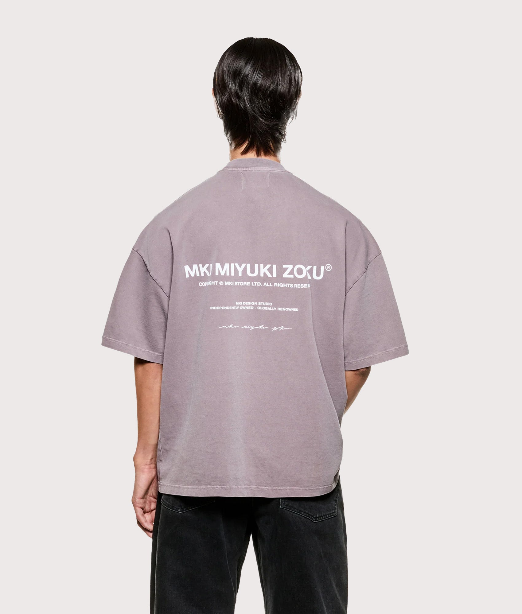 MKI MIYUKI ZOKU Design Studio T-Shirt in Pigment Raisin at EQVVS Menswear. Model back shot.