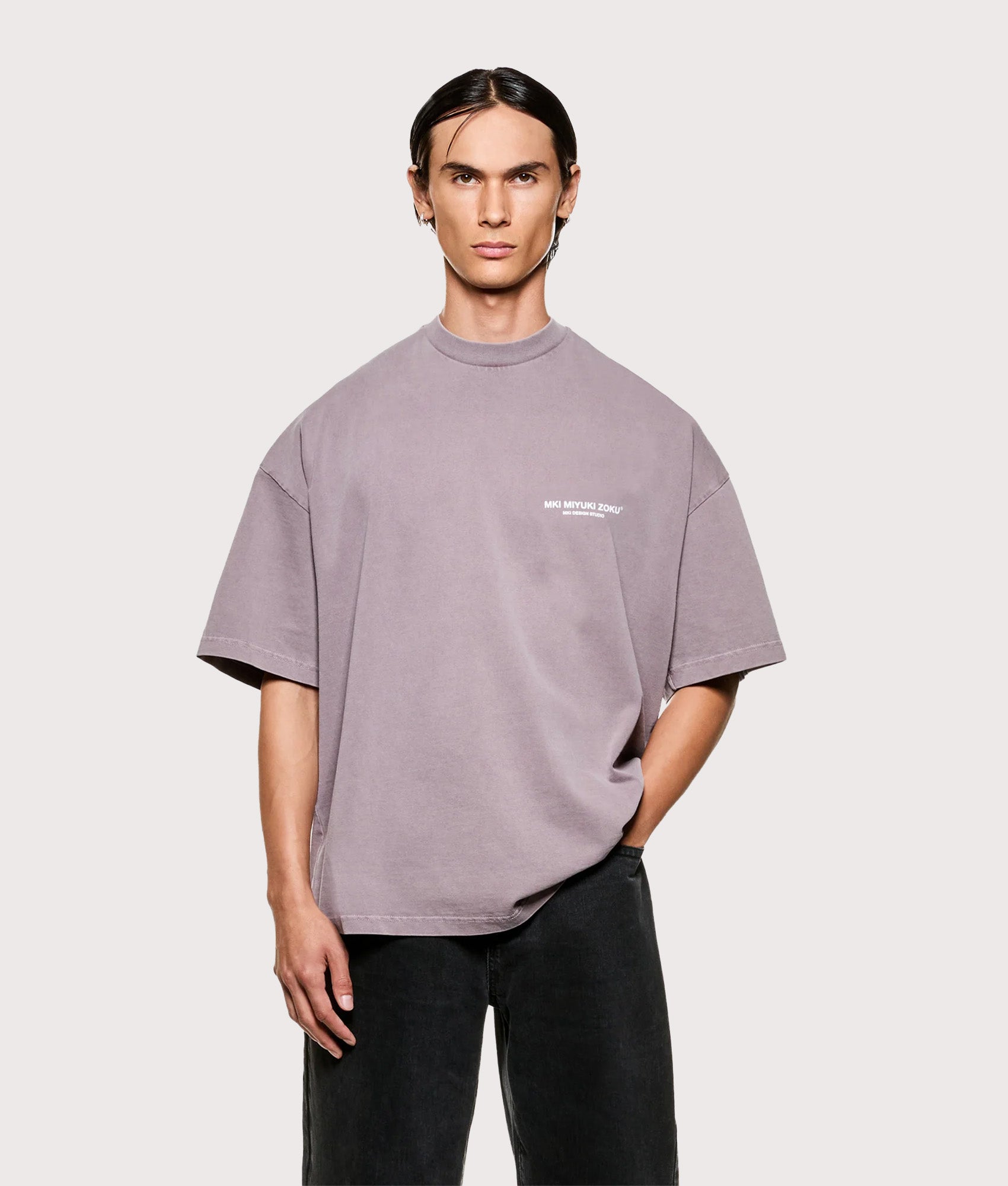 MKI MIYUKI ZOKU Design Studio T-Shirt in Pigment Raisin at EQVVS Menswear. Model front shot.