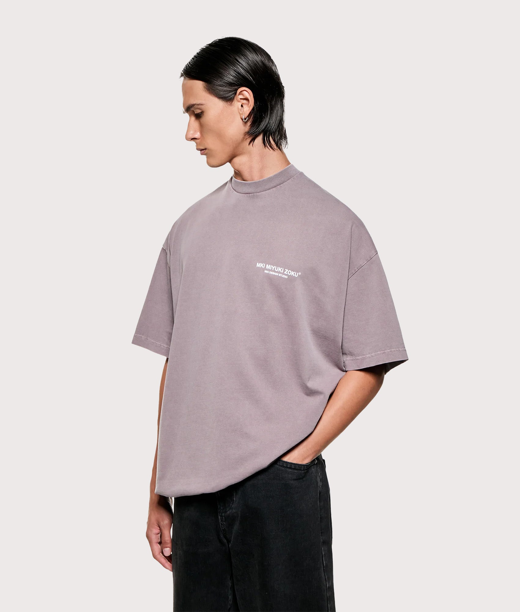 MKI MIYUKI ZOKU Design Studio T-Shirt in Pigment Raisin at EQVVS Menswear. Angled model front shot.
