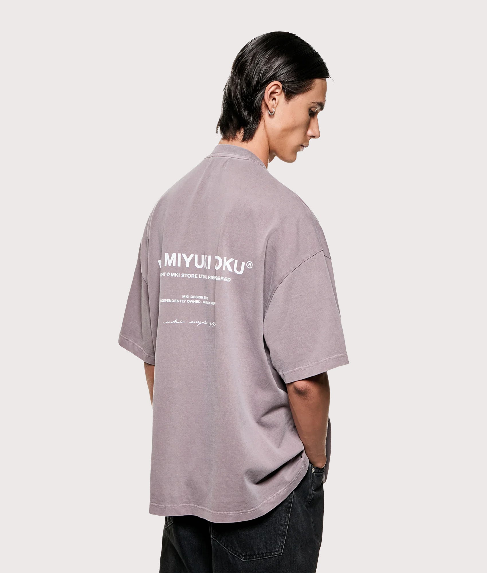 MKI MIYUKI ZOKU Design Studio T-Shirt in Pigment Raisin at EQVVS Menswear. Angled model front shot.