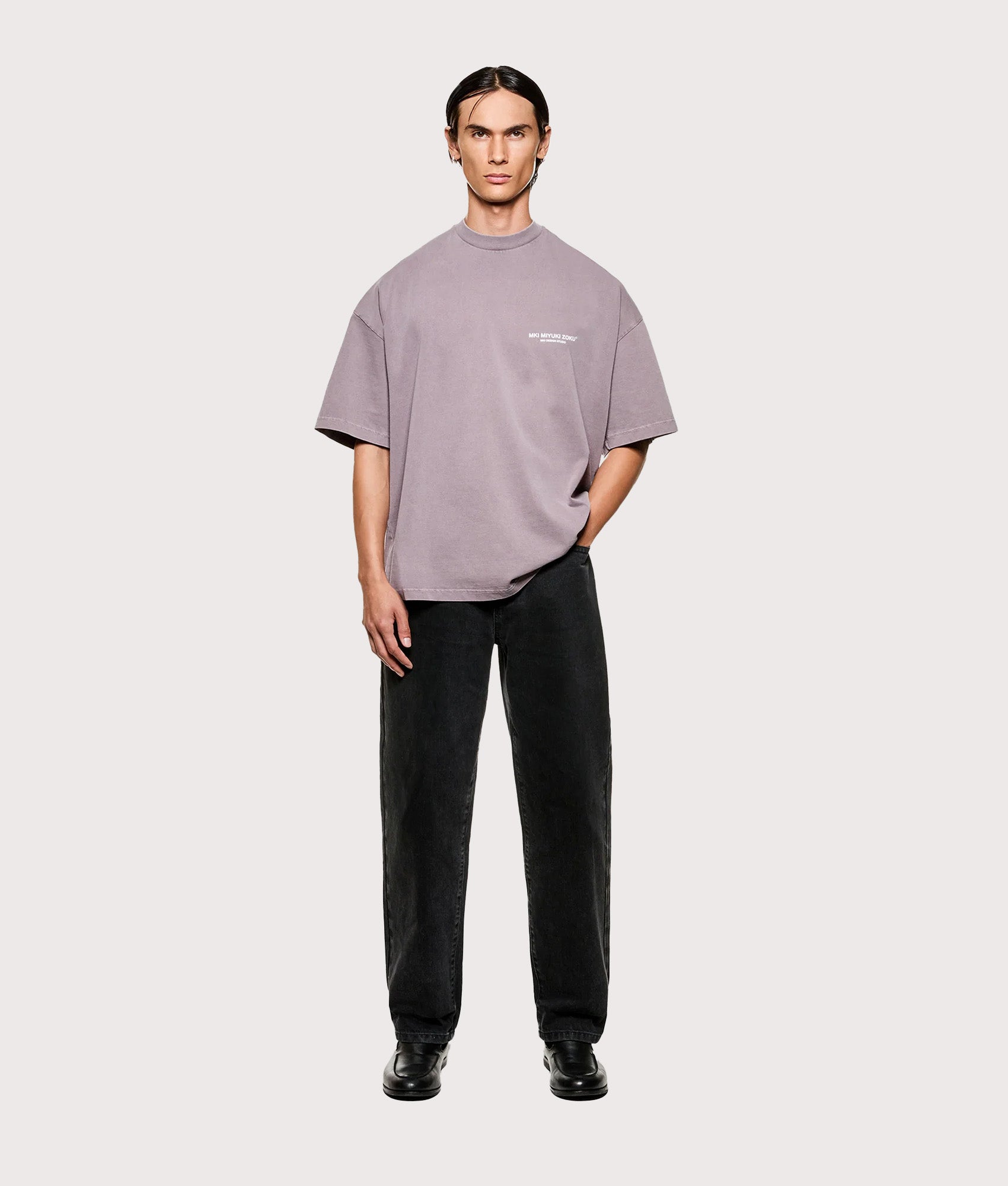 MKI MIYUKI ZOKU Design Studio T-Shirt in Pigment Raisin at EQVVS Menswear. Model full front shot.
