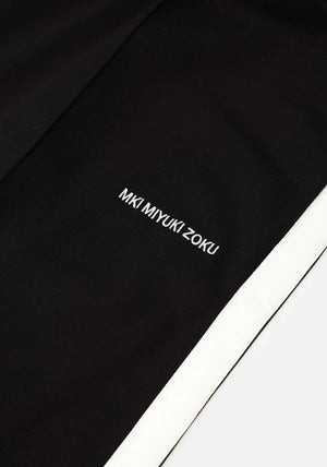 Wide fit track pants MKI Miyuki Zoku black. Detail shot.