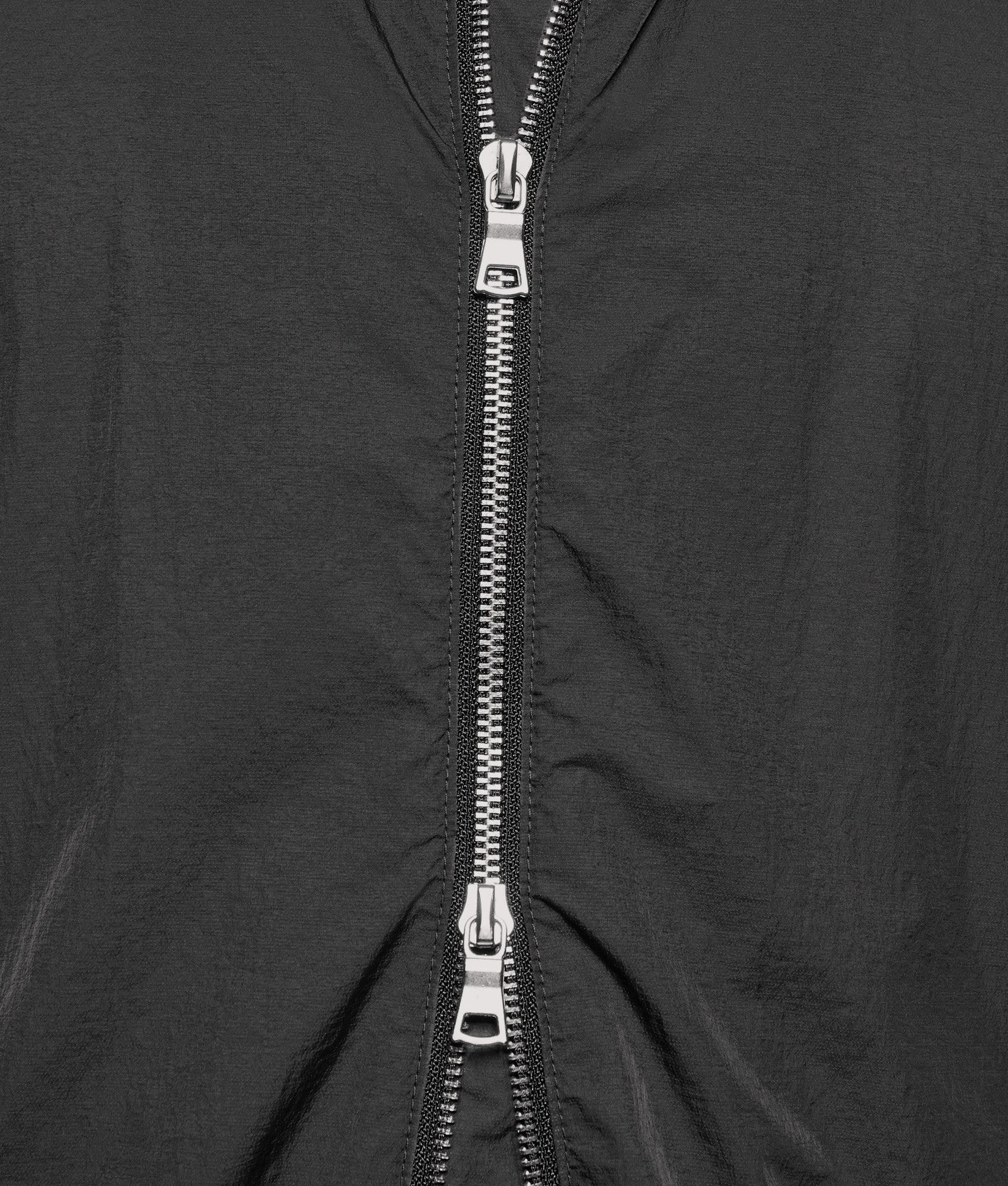 MKI MIYUKI ZOKU Box Fit Hyperlight Hooded Wind Jacket in Black at EQVVS Menswear. Second detail shot.