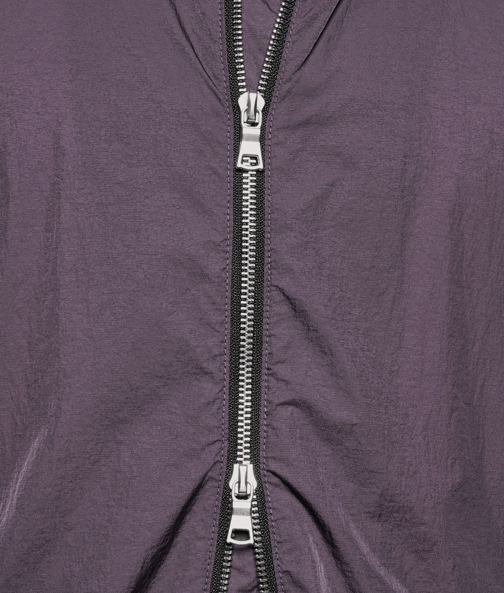 MKI MIYUKI ZOKU Box Fit Hyperlight Hooded Wind Jacket in Raisin at EQVVS Menswear. Second detail shot.
