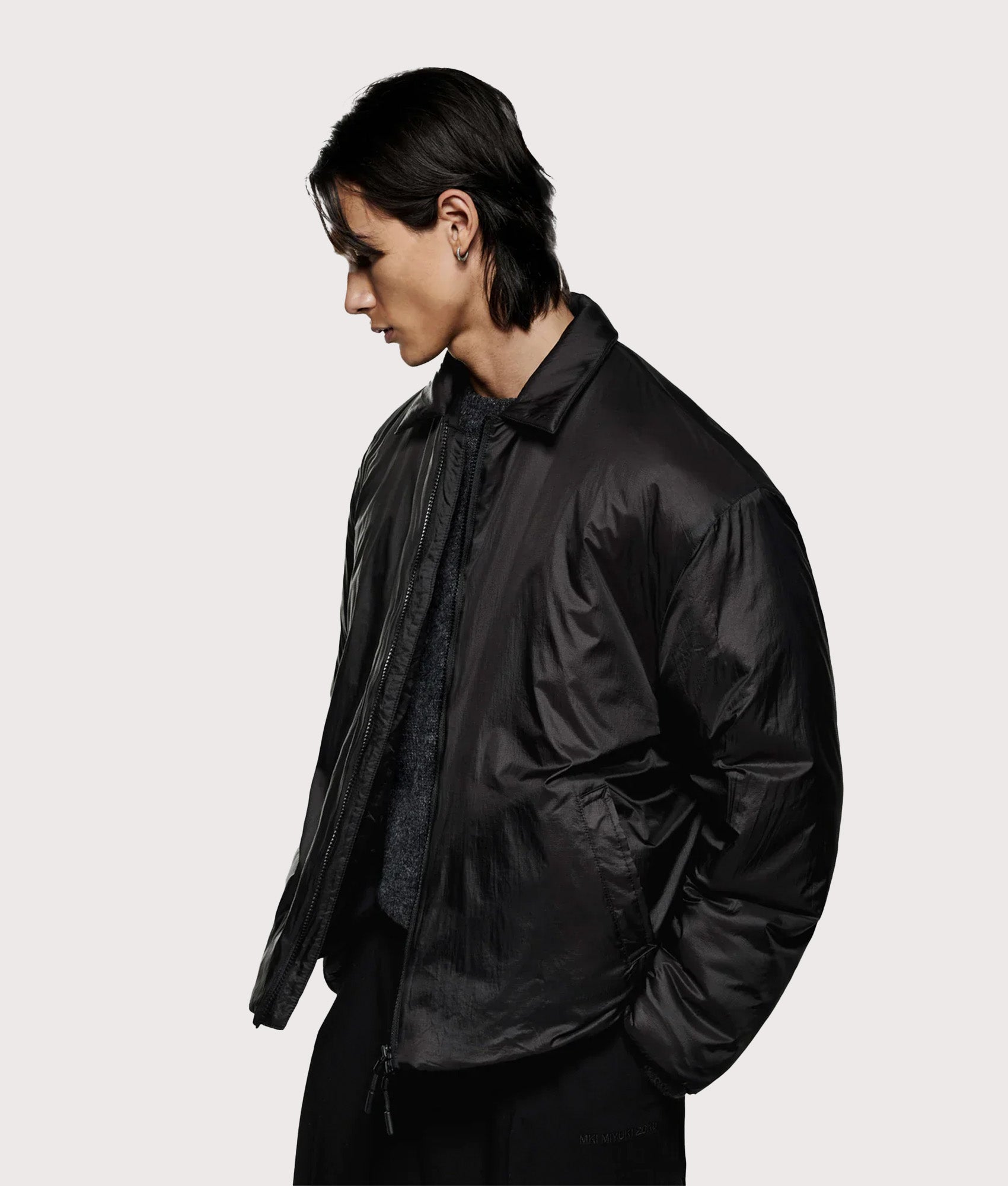 MKI MIYUKI ZOKU Relaxed Fit Insulated Loft Rider Jacket in Black at EQVVS Menswear. Angled model front shot.