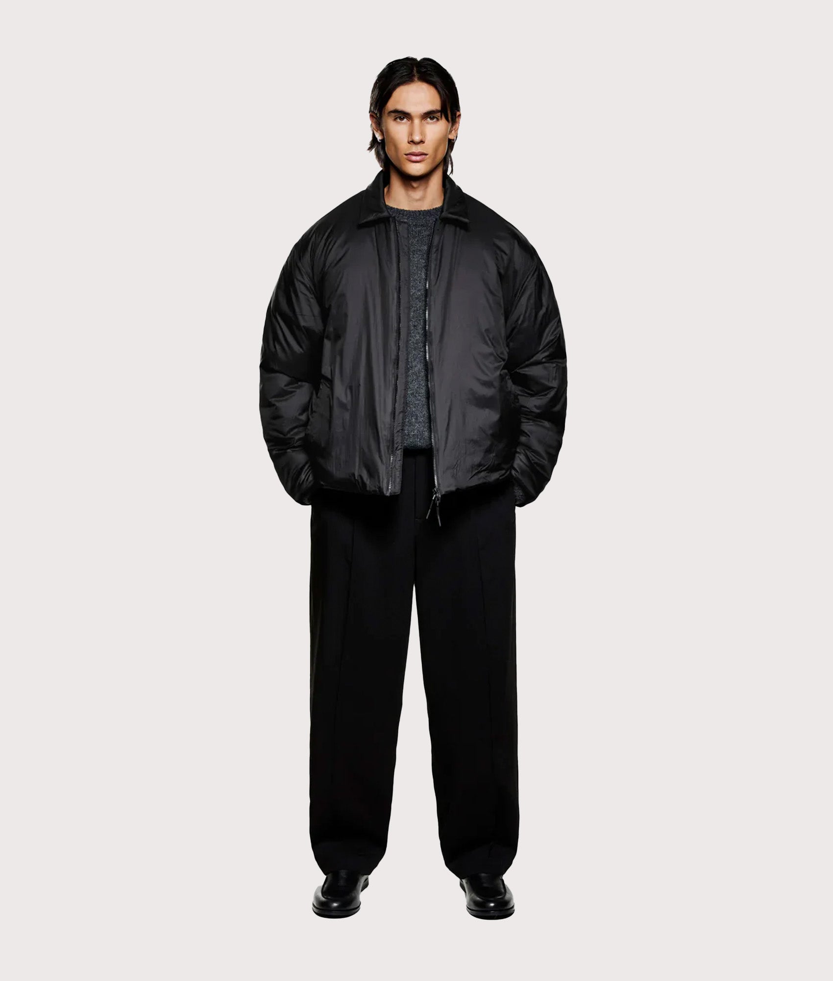 MKI MIYUKI ZOKU Relaxed Fit Insulated Loft Rider Jacket in Black at EQVVS Menswear. Model full front shot.