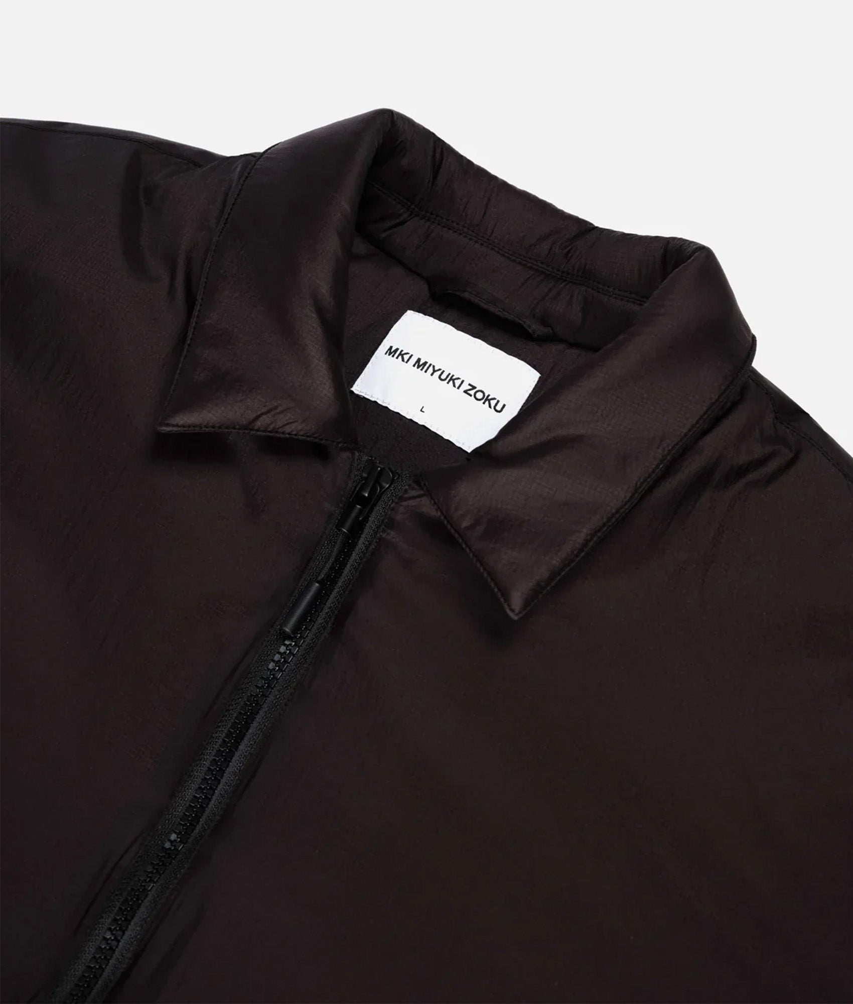 MKI MIYUKI ZOKU Relaxed Fit Insulated Loft Rider Jacket in Black at EQVVS Menswear. Collar shot.