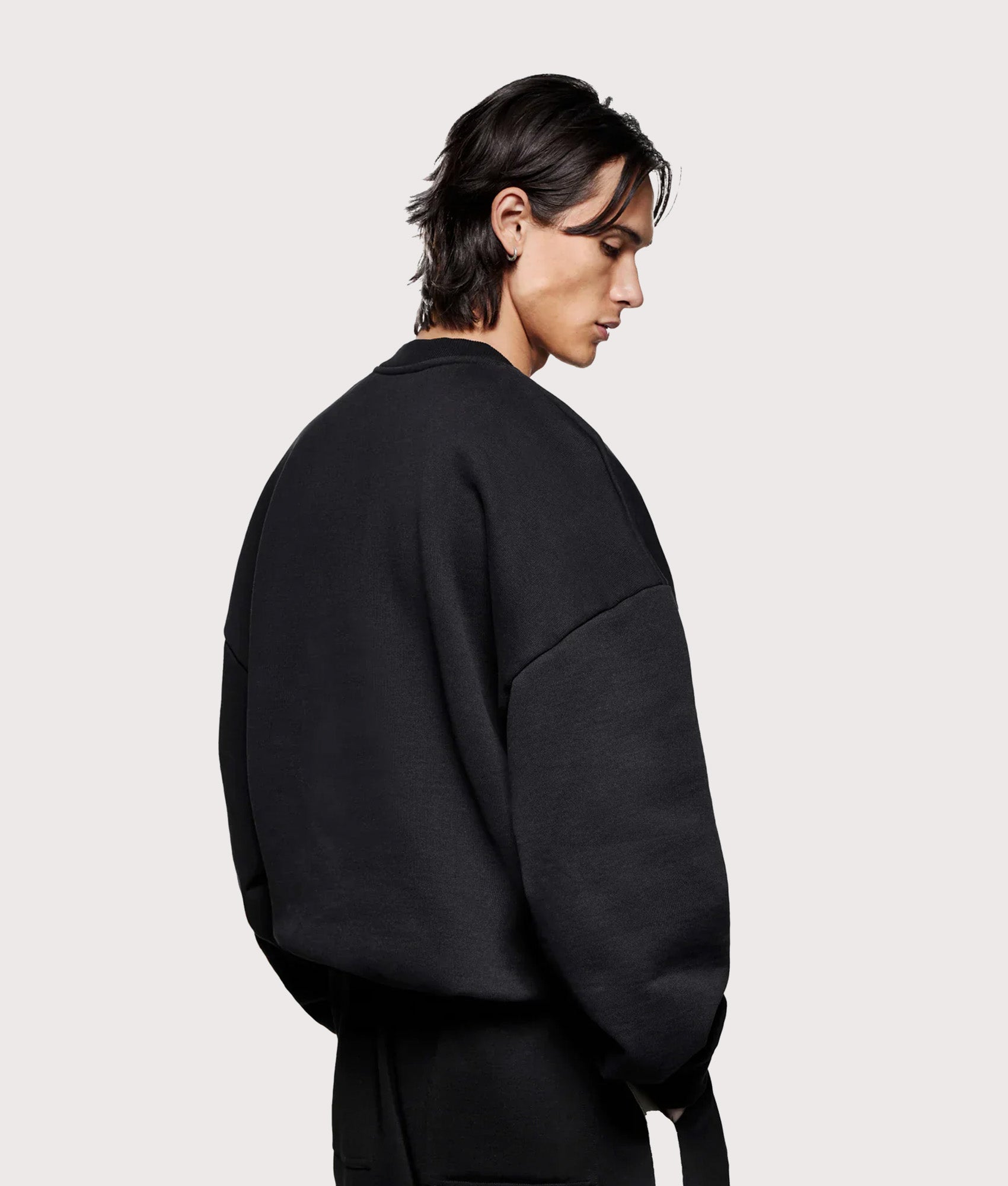 MKI MIYUKI ZOKU Oversized Linear Crewneck Sweatshirt in Black at EQVVS Menswear. Angled back shot.