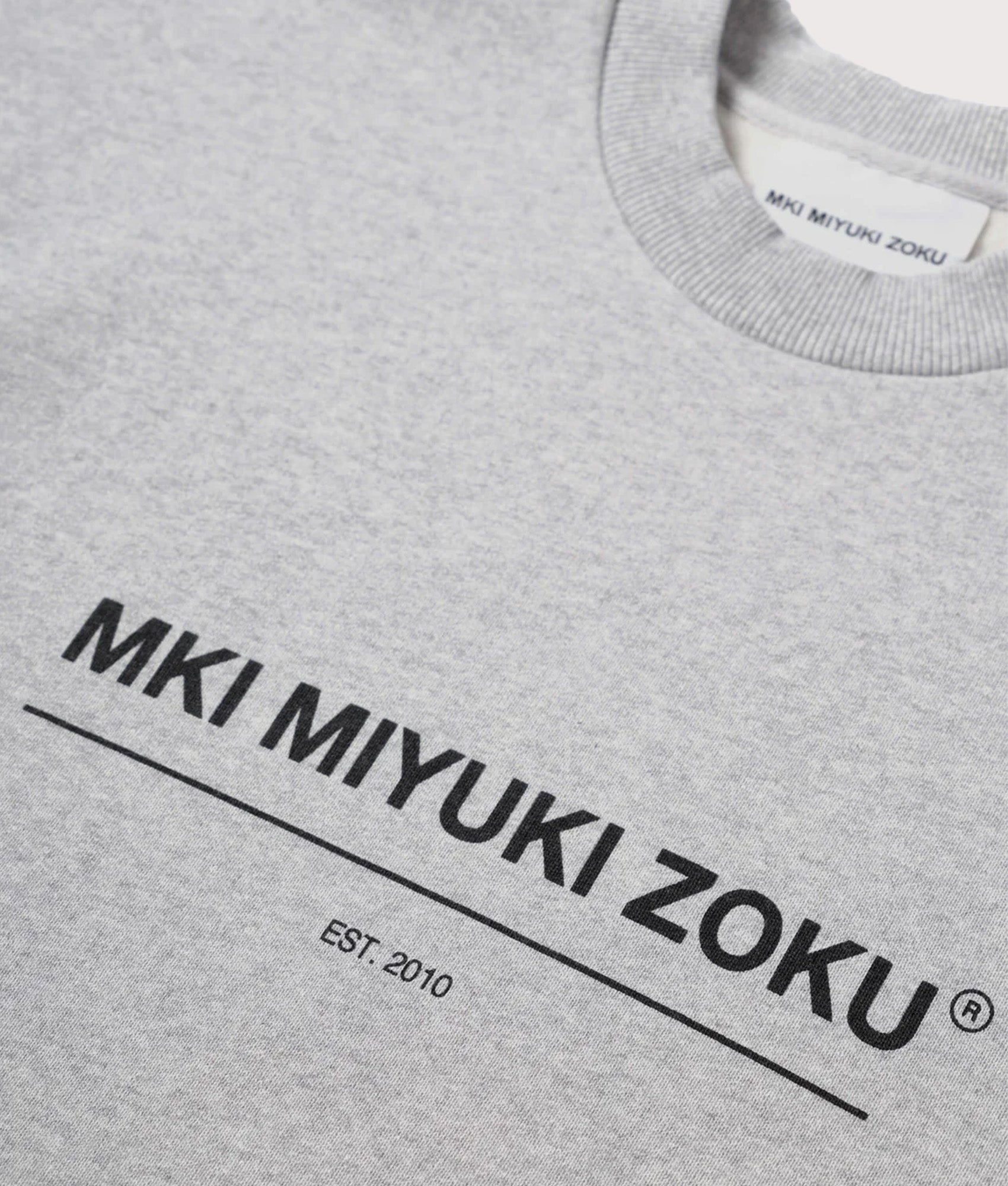 MKI MIYUKI ZOKU Oversized Linear Crewneck Sweatshirt in Grey at EQVVS Menswear. Detail shot.