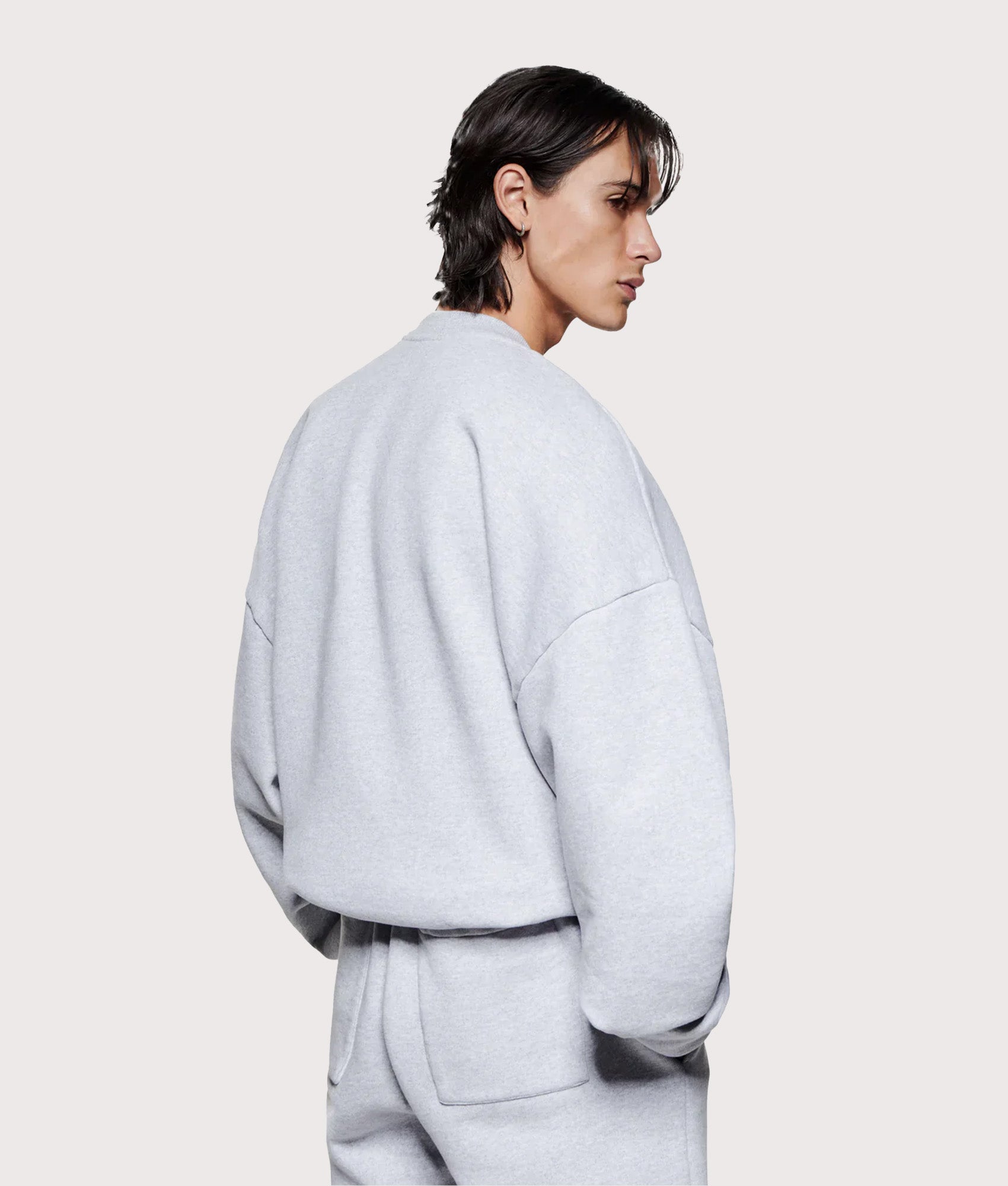 MKI MIYUKI ZOKU Oversized Linear Crewneck Sweatshirt in Grey at EQVVS Menswear. Angled model back shot.