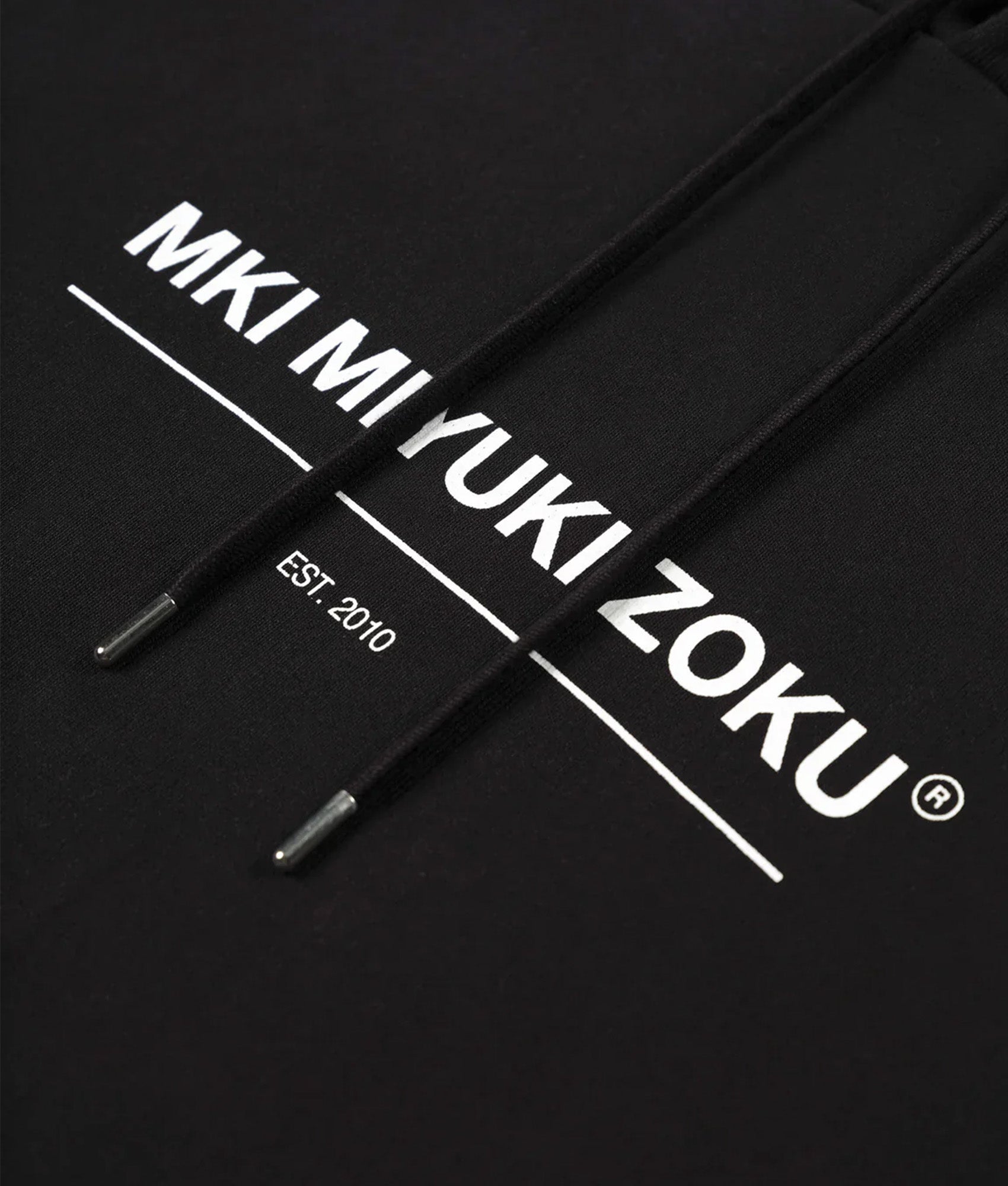 MKI MIYUKI ZOKU Oversized Linear Hoodie in Black at EQVVS Menswear.  Detail shot.
