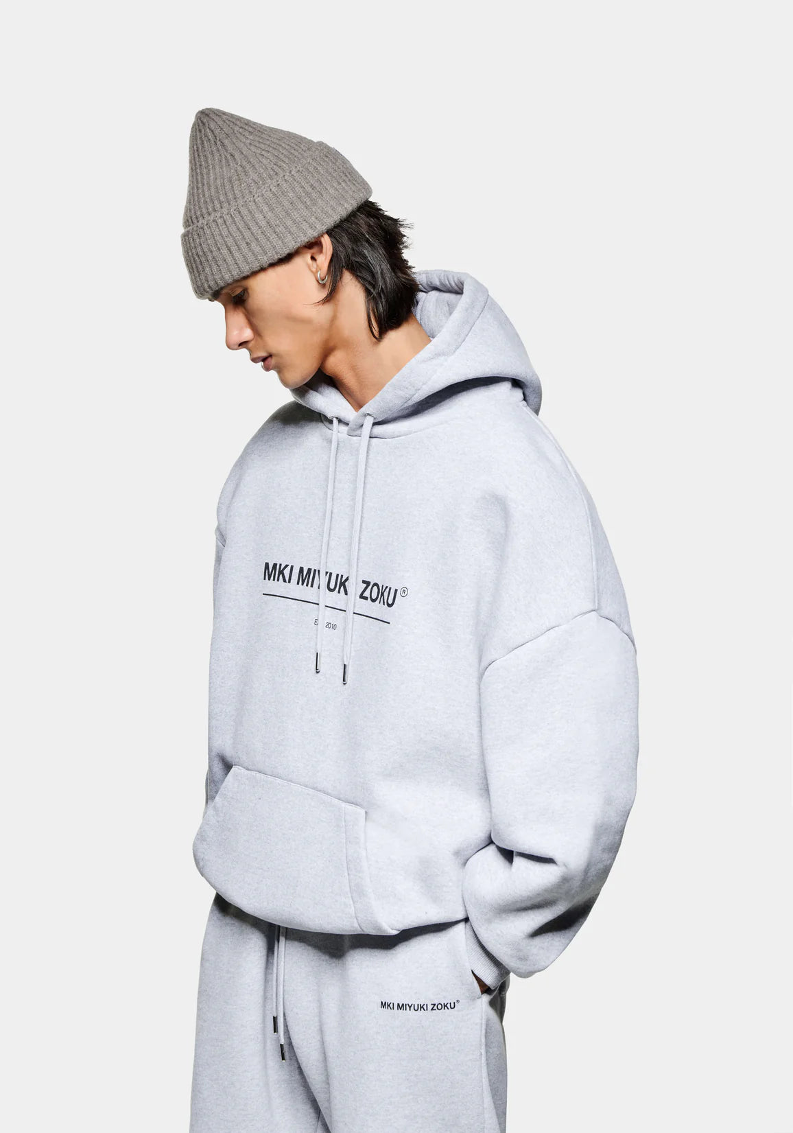 MKI Miyuki Zoku Linear Hoodie in Grey. Shot at EQVVS.  Front shot model. 