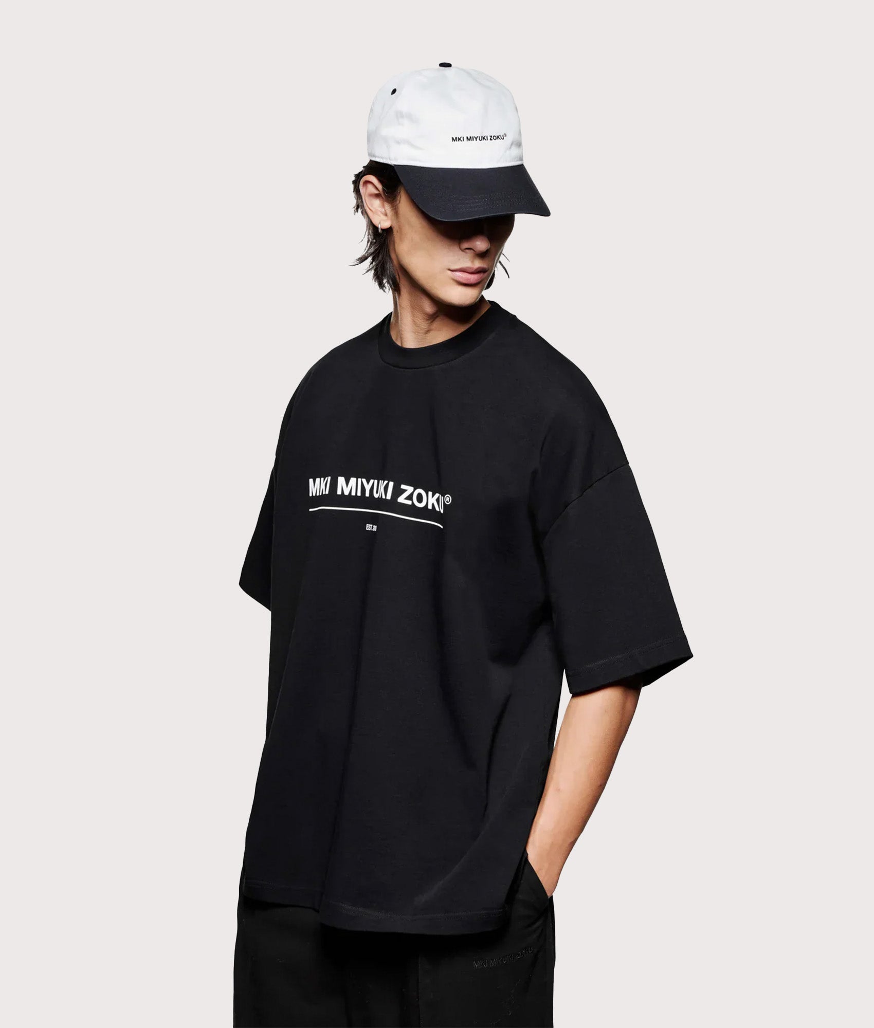 MKI MIYUKI ZOKU Oversized Linear T-Shirt in Black at EQVVS Menswear. Angled model front shot.