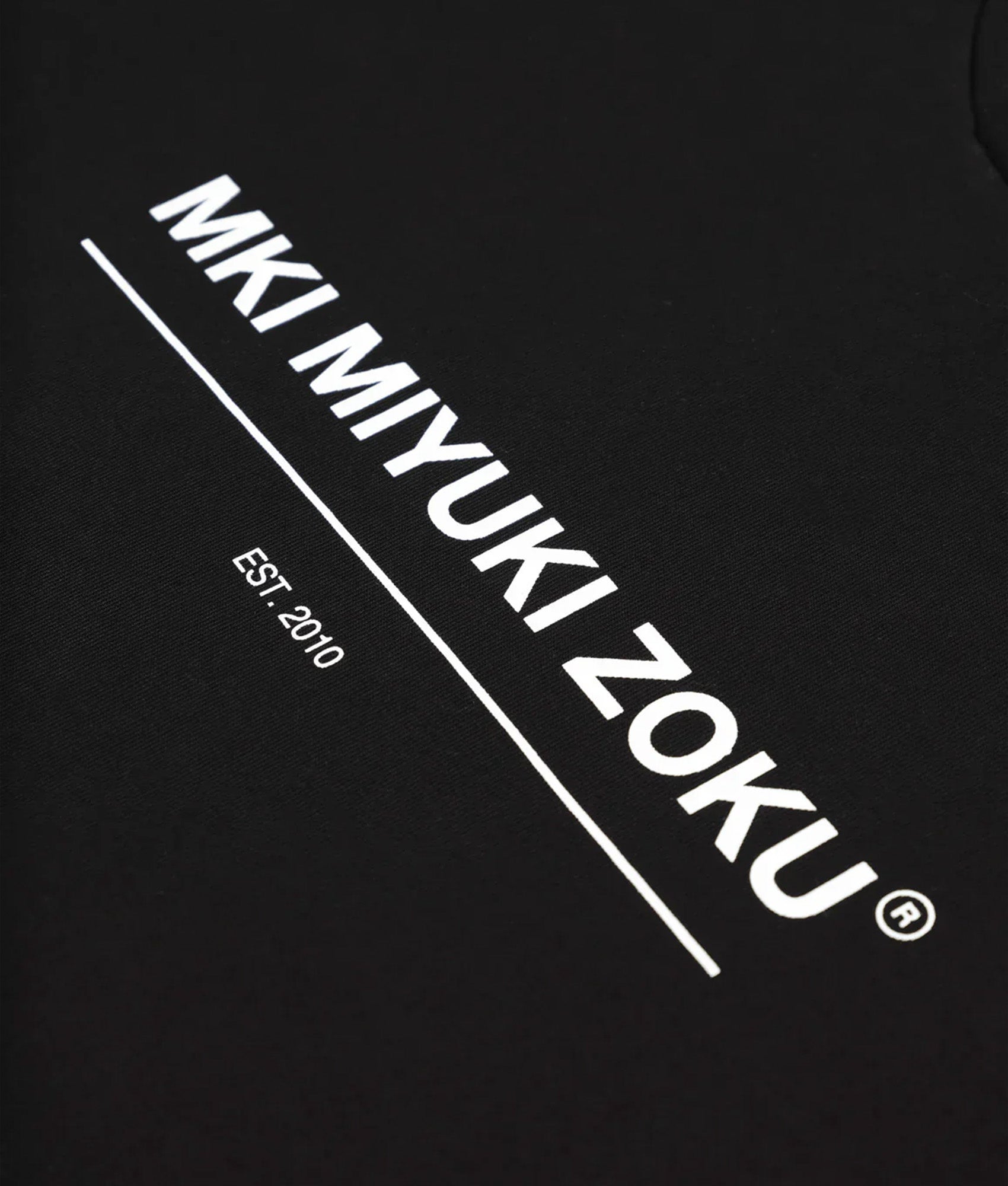 MKI MIYUKI ZOKU Oversized Linear T-Shirt in Black at EQVVS Menswear. Detail shot.