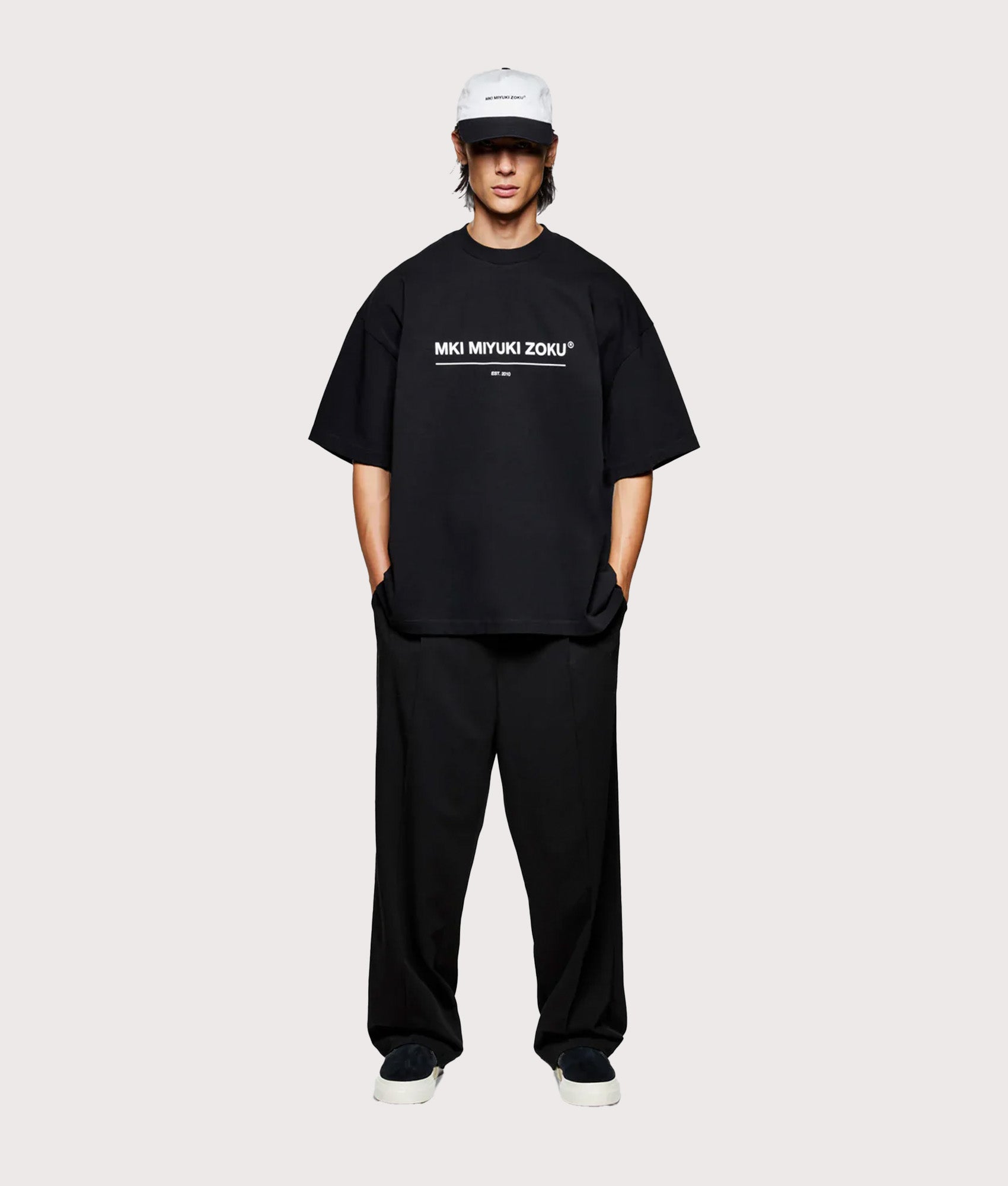 MKI MIYUKI ZOKU Oversized Linear T-Shirt in Black at EQVVS Menswear. Model full front shot.