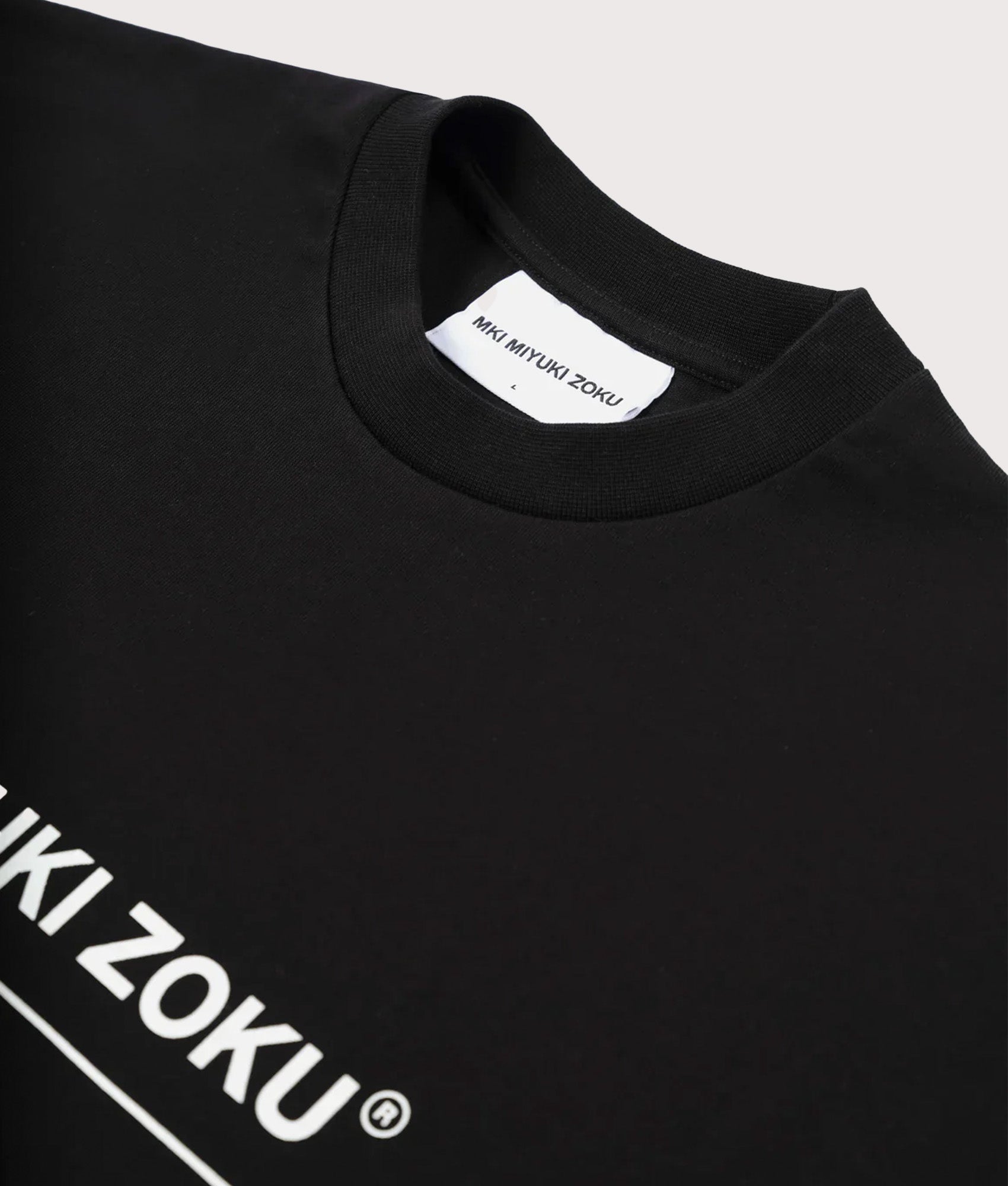 MKI MIYUKI ZOKU Oversized Linear T-Shirt in Black at EQVVS Menswear. Collar shot. 
