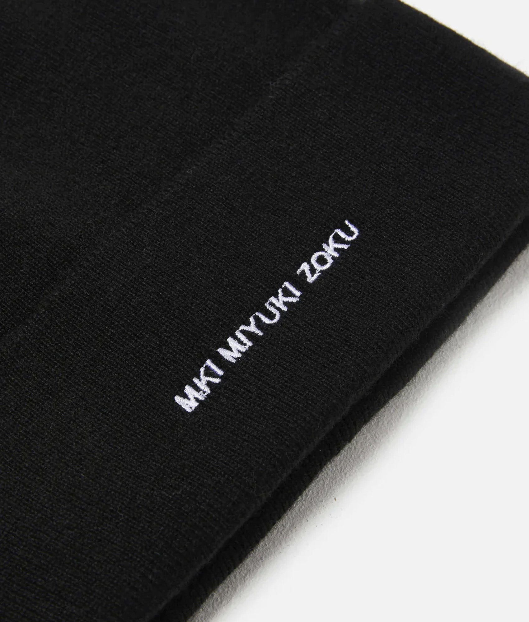 MKI MIYUKI ZOKU Embroidered Merino Beanie in Black at EQVVS Menswear. Detail shot.