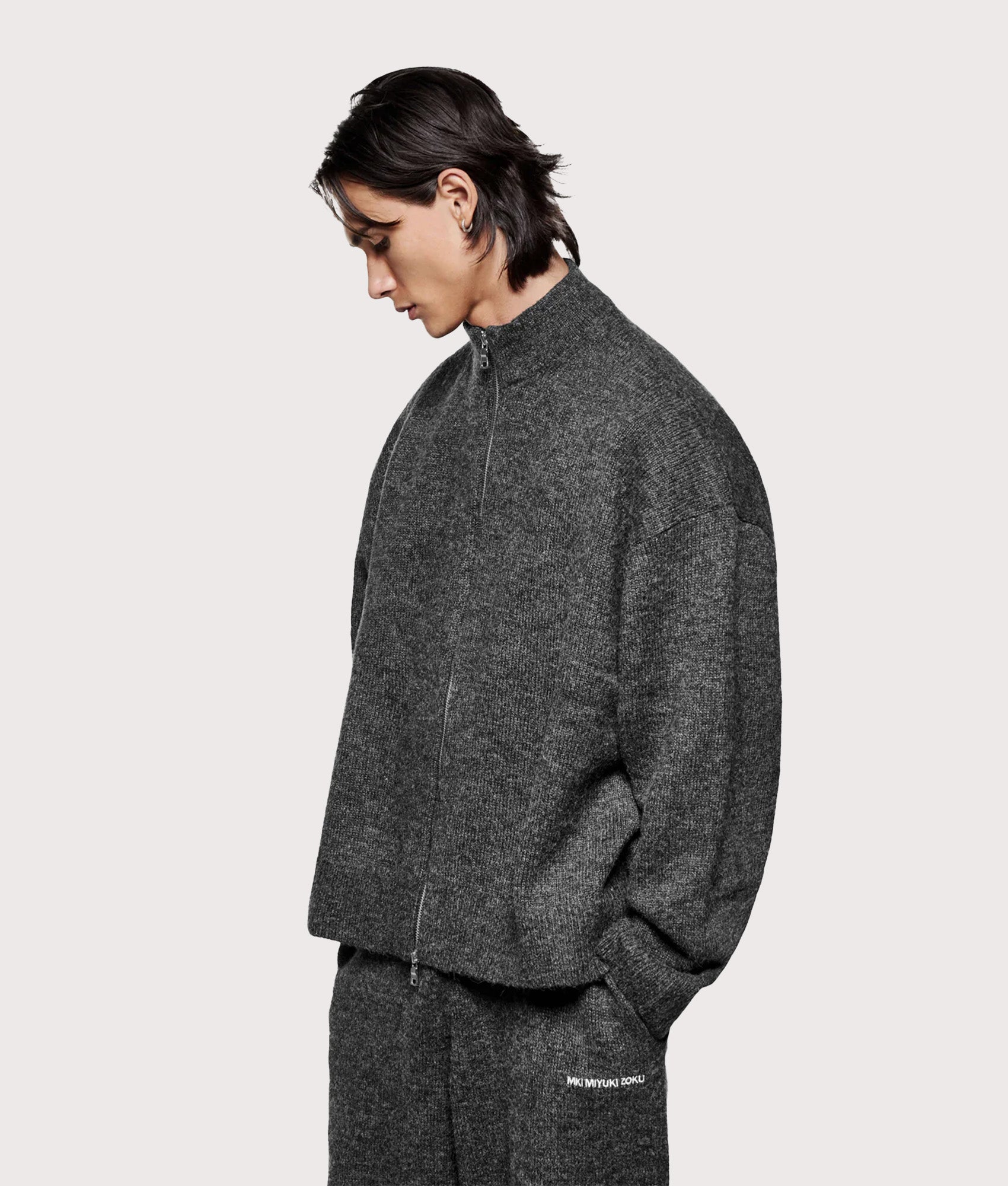 MKI MIYUKI ZOKU Oversized Fit Mohair Blend Knit Track Jacket in Charcoal at EQVVS Menswear. Angled model front shot.