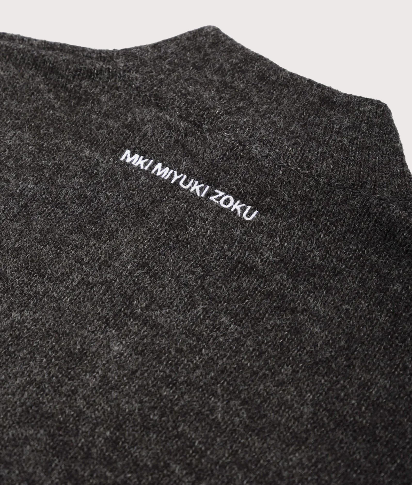 MKI MIYUKI ZOKU Oversized Fit Mohair Blend Knit Track Jacket in Charcoal at EQVVS Menswear. Detail shot.