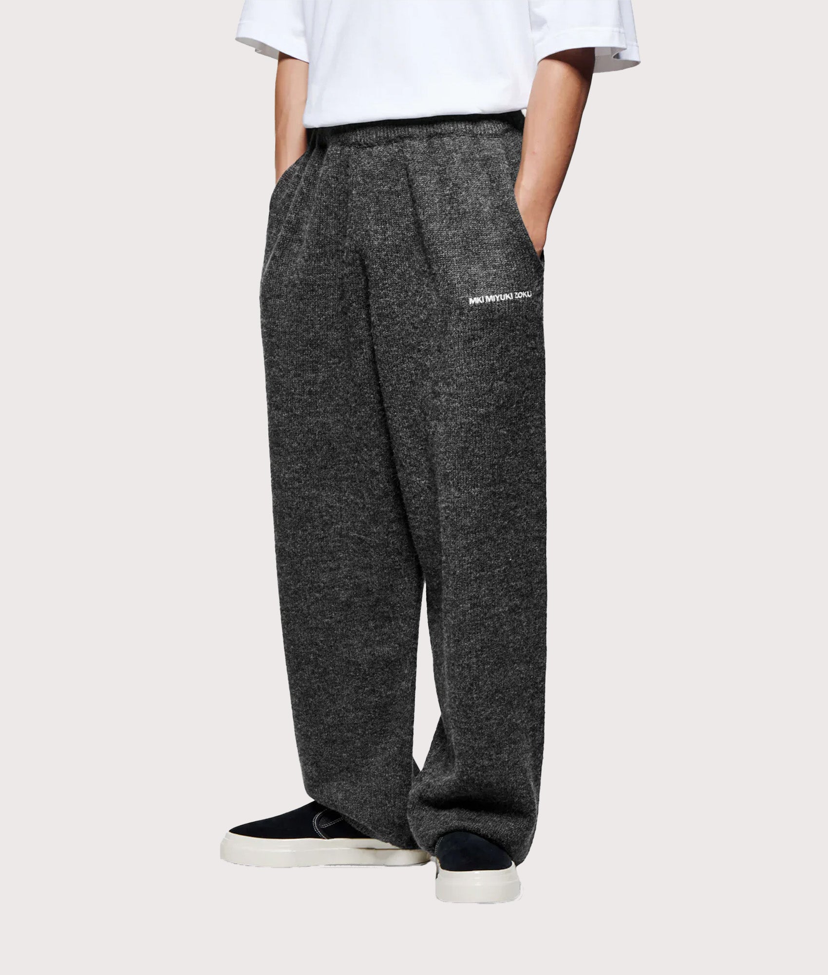MKI MIYUKI ZOKU Relaxed Fit Mohair Blend Knit Wide Leg Joggers in Charcoal at EQVVS Menswear. Angled model front shot.