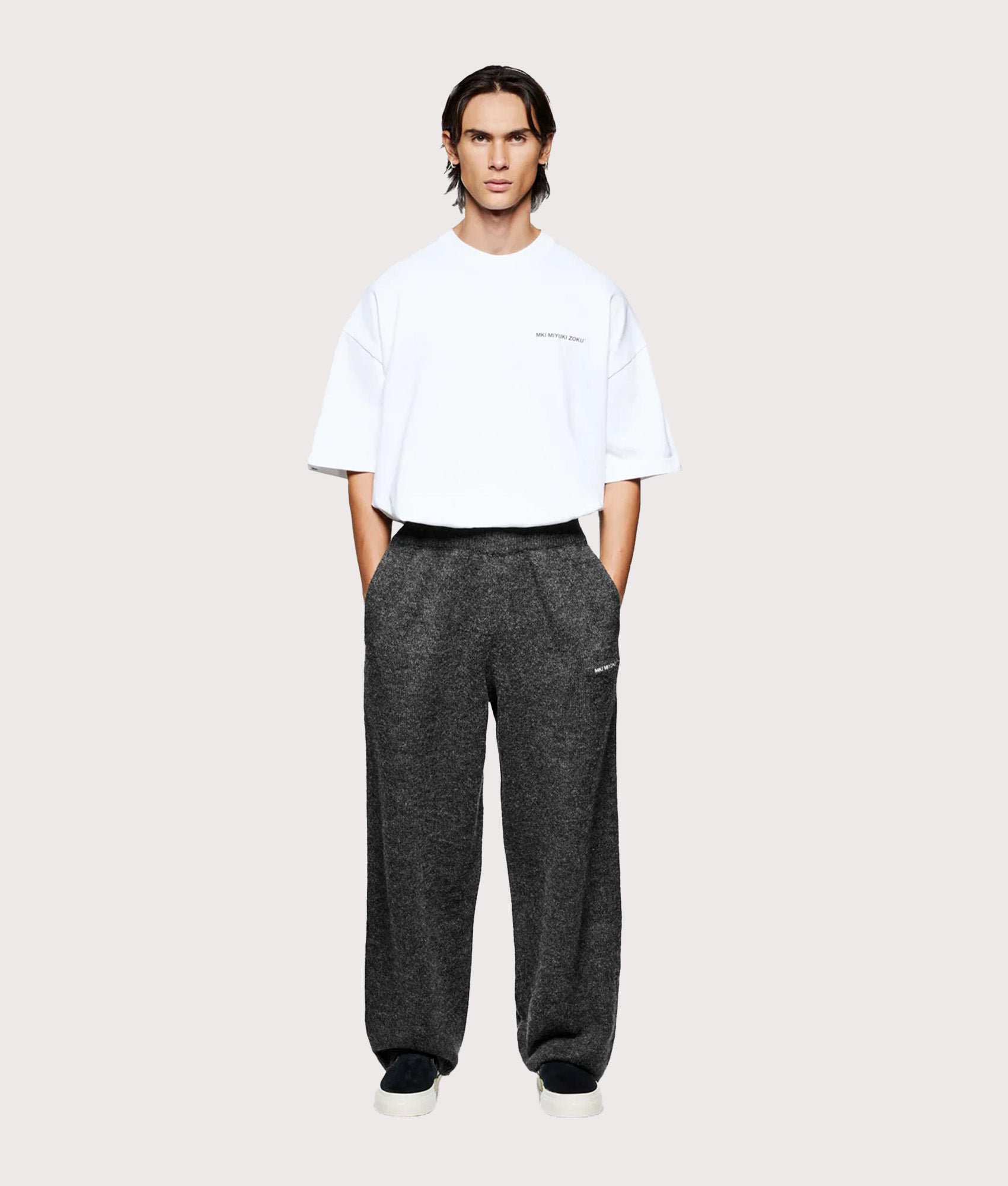 MKI MIYUKI ZOKU Relaxed Fit Mohair Blend Knit Wide Leg Joggers in Charcoal at EQVVS Menswear. Model full front shot.