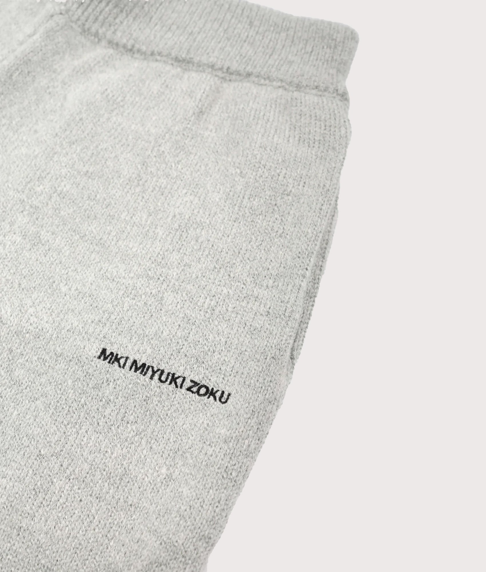 MKI MIYUKI ZOKU Relaxed Fit Mohair Blend Knit Wide Leg Joggers in Light Grey at EQVVS Menswear. Detail shot.