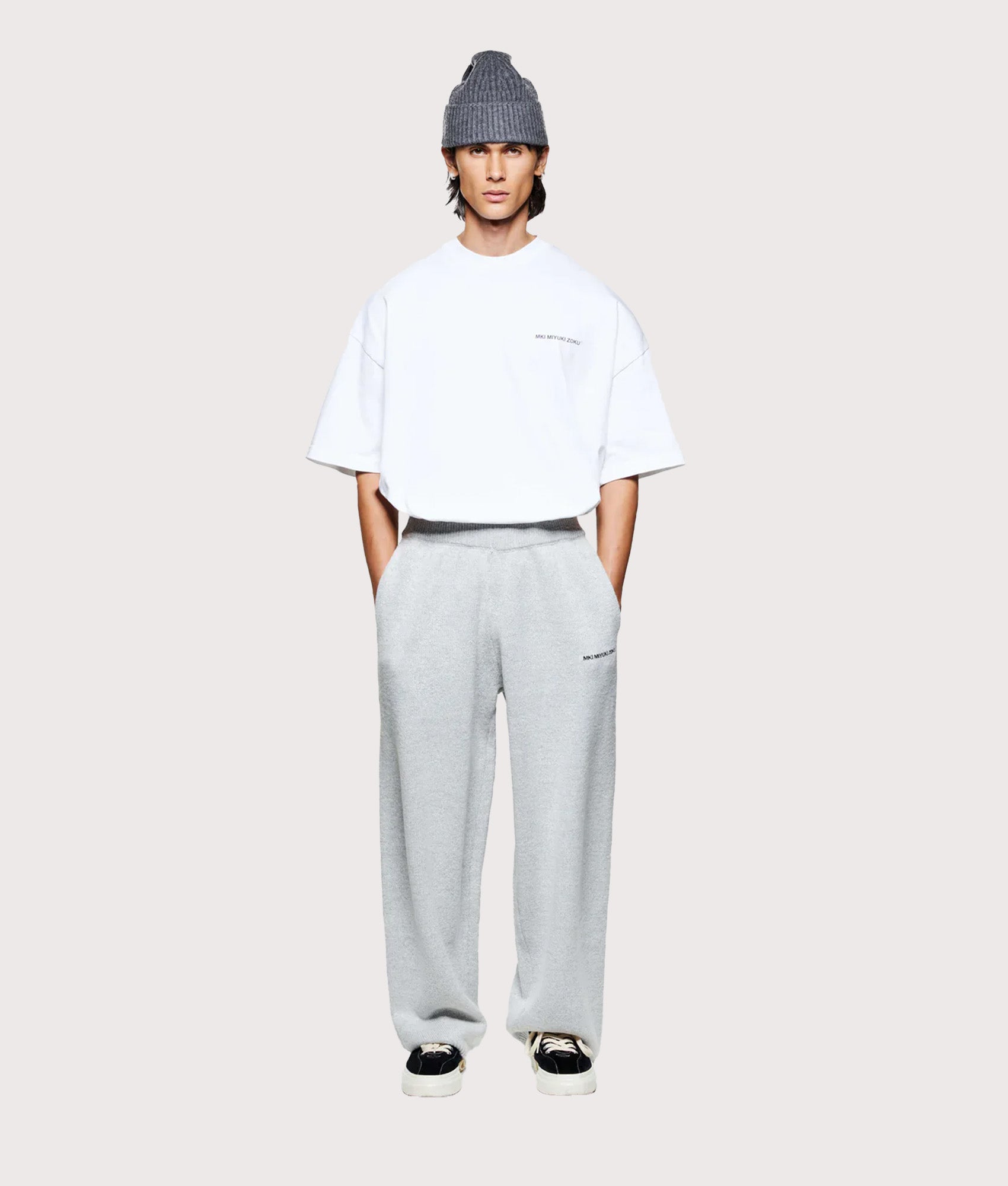 MKI MIYUKI ZOKU Relaxed Fit Mohair Blend Knit Wide Leg Joggers in Light Grey at EQVVS Menswear. Model full front shot.