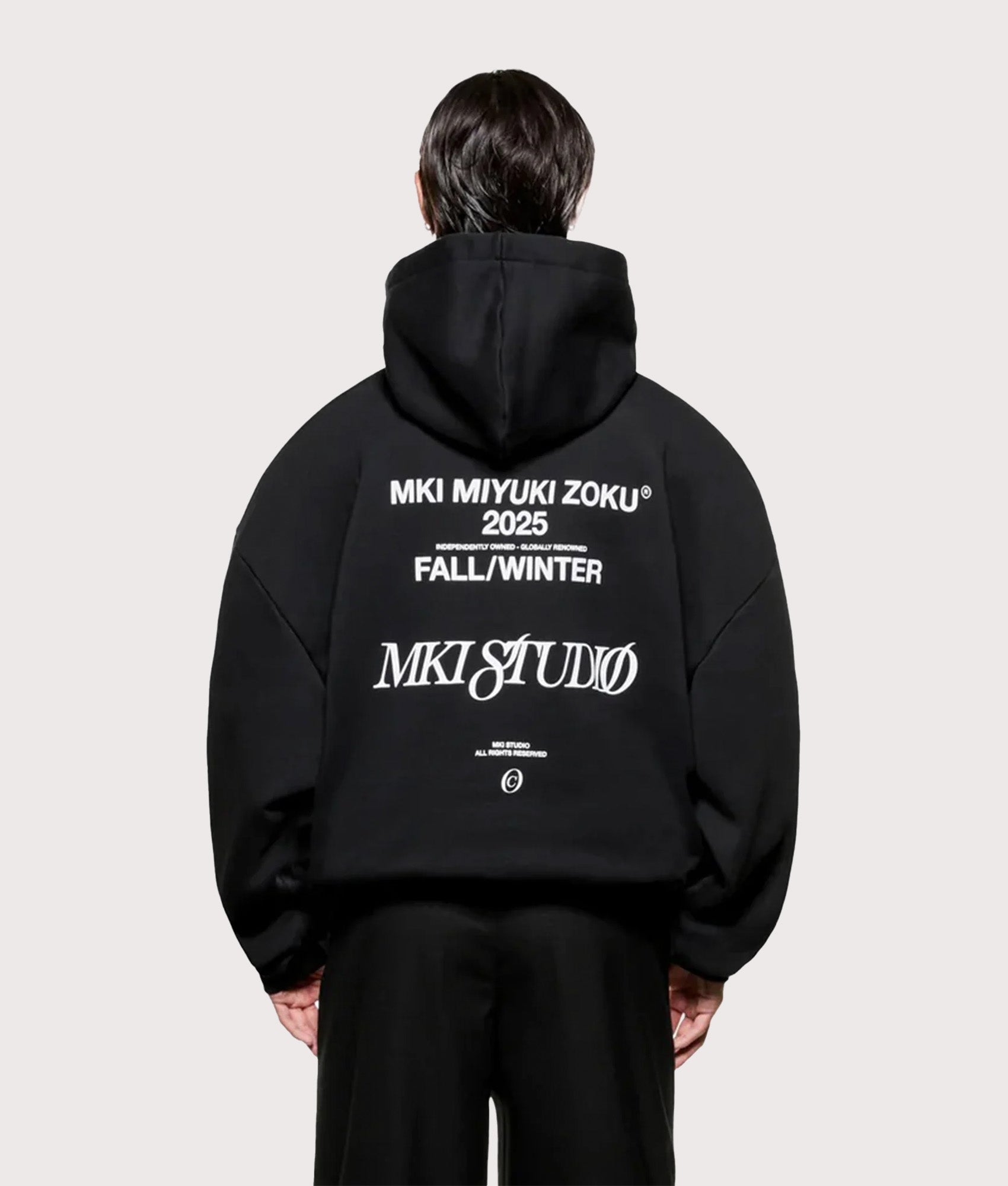 MKI MIYUKI ZOKU Script hoodie in Black at EQVVS Menswear. Model back shot.