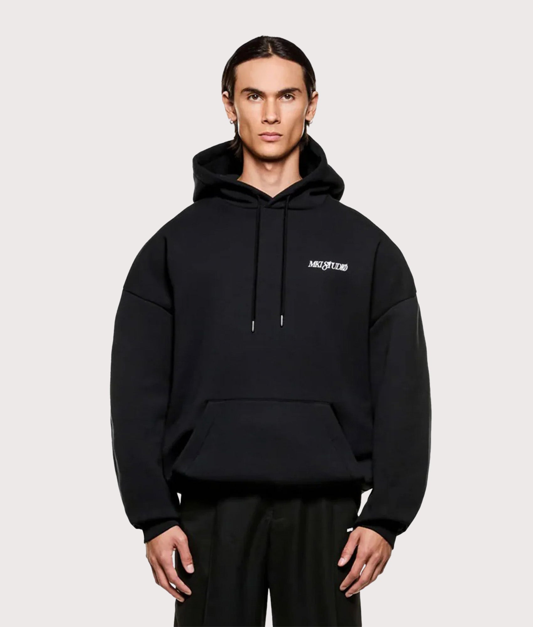 MKI MIYUKI ZOKU Script hoodie in Black at EQVVS Menswear. Model front shot.